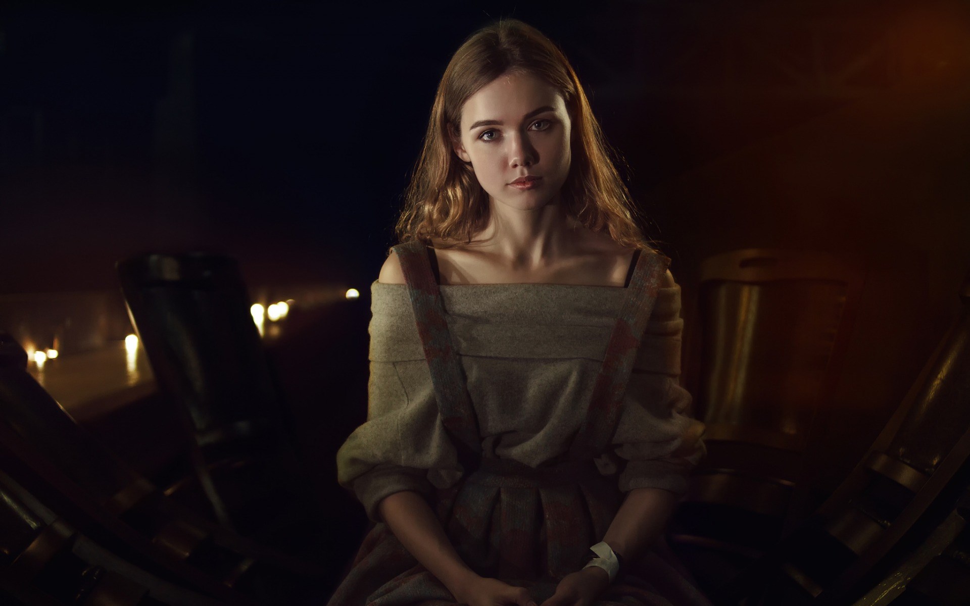 Young woman in historical dress sitting in dim light HD Wallpaper
