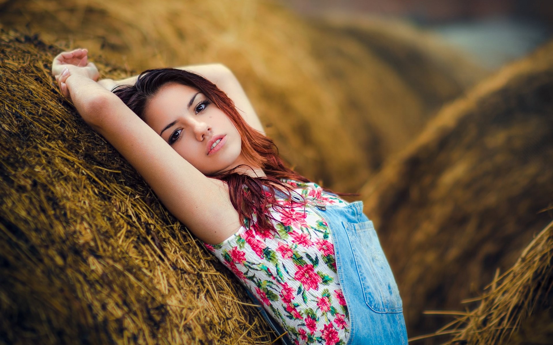 Woman lying on hay bales HD Wallpaper