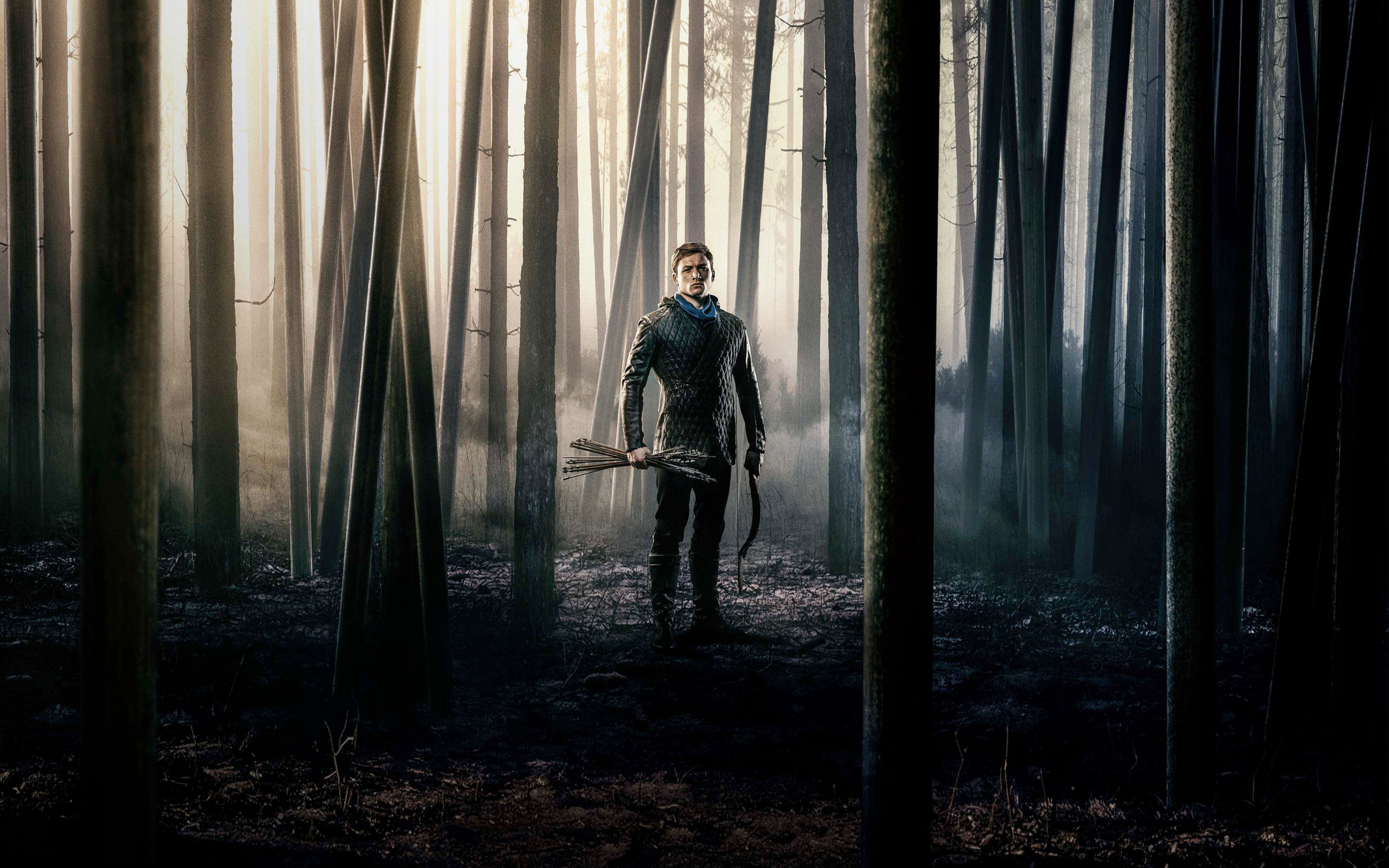 Taron Egerton as Robin Hood in a forest HD Wallpaper