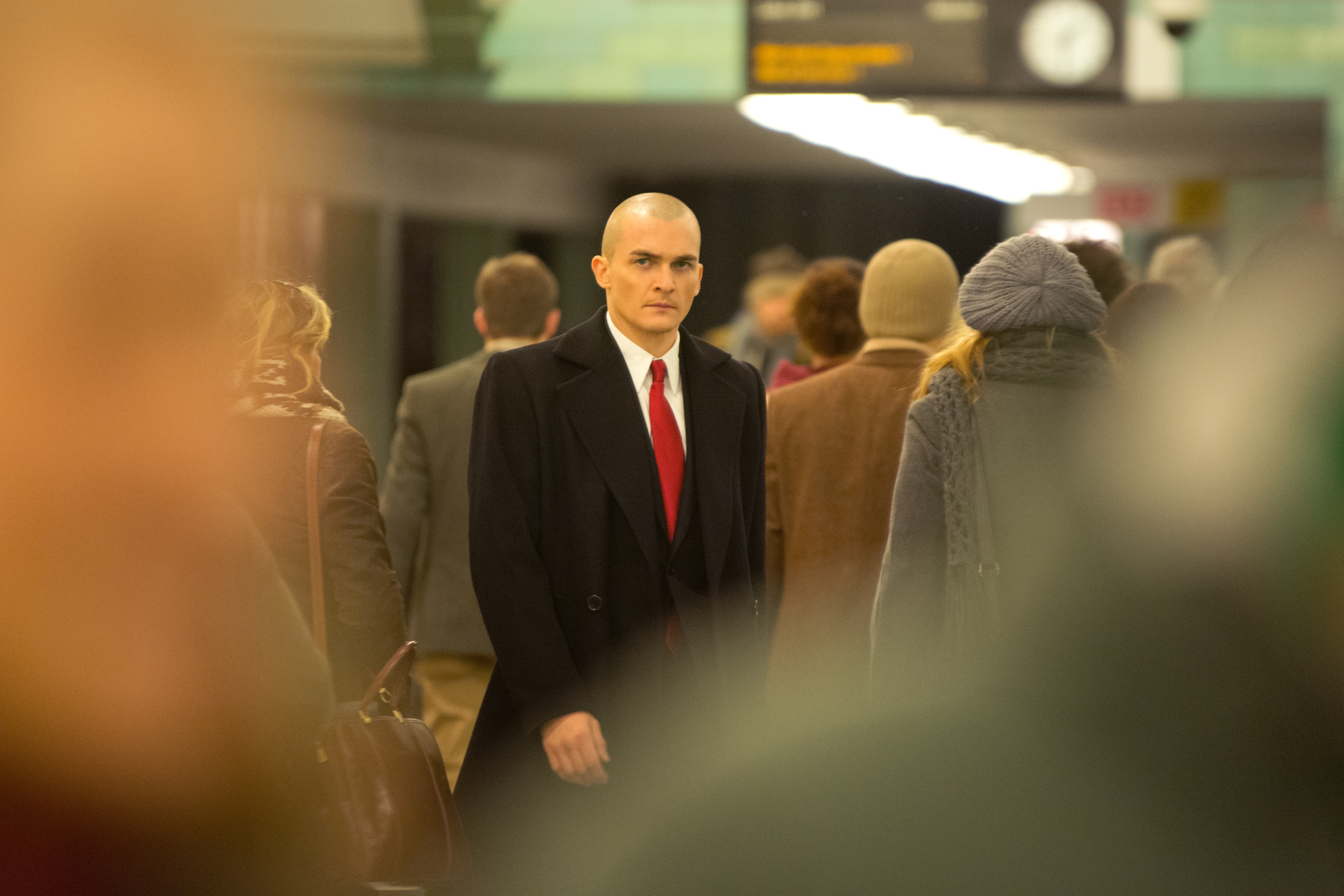 Rupert Friend as Agent 47 in a crowd HD Wallpaper