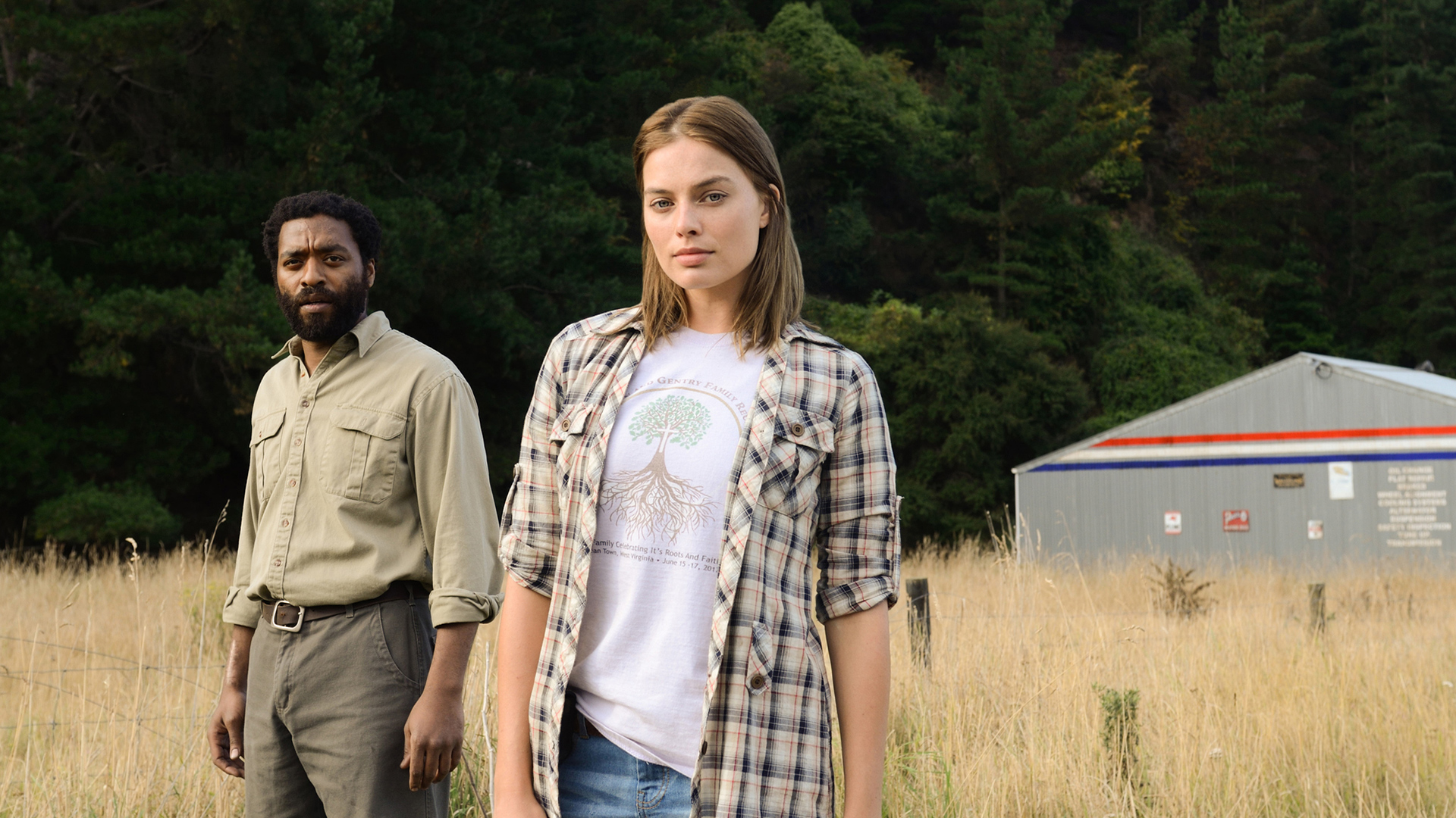 Chiwetel Ejiofor and Margot Robbie in a field HD Wallpaper