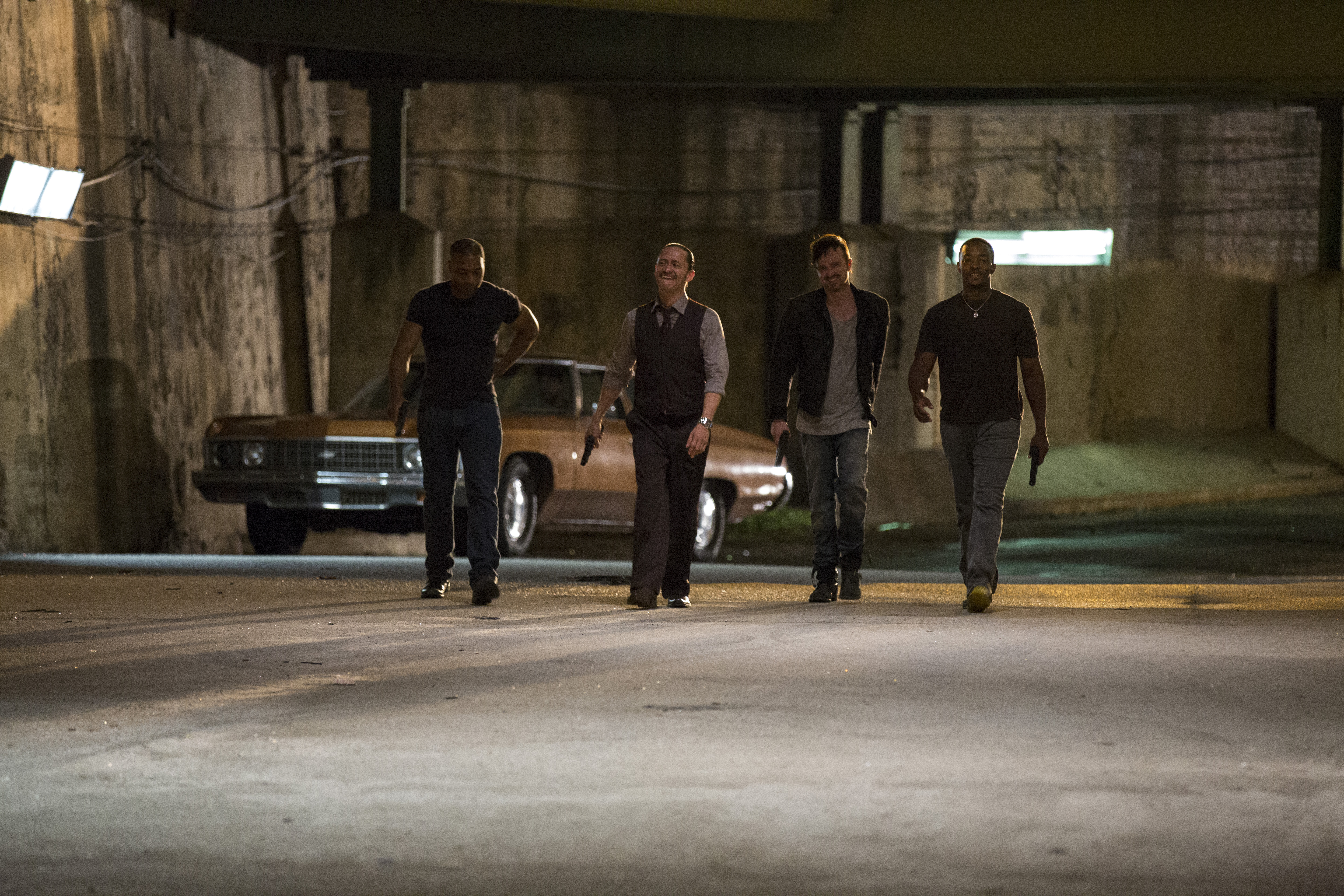 Four men with guns walking in a tunnel HD Wallpaper