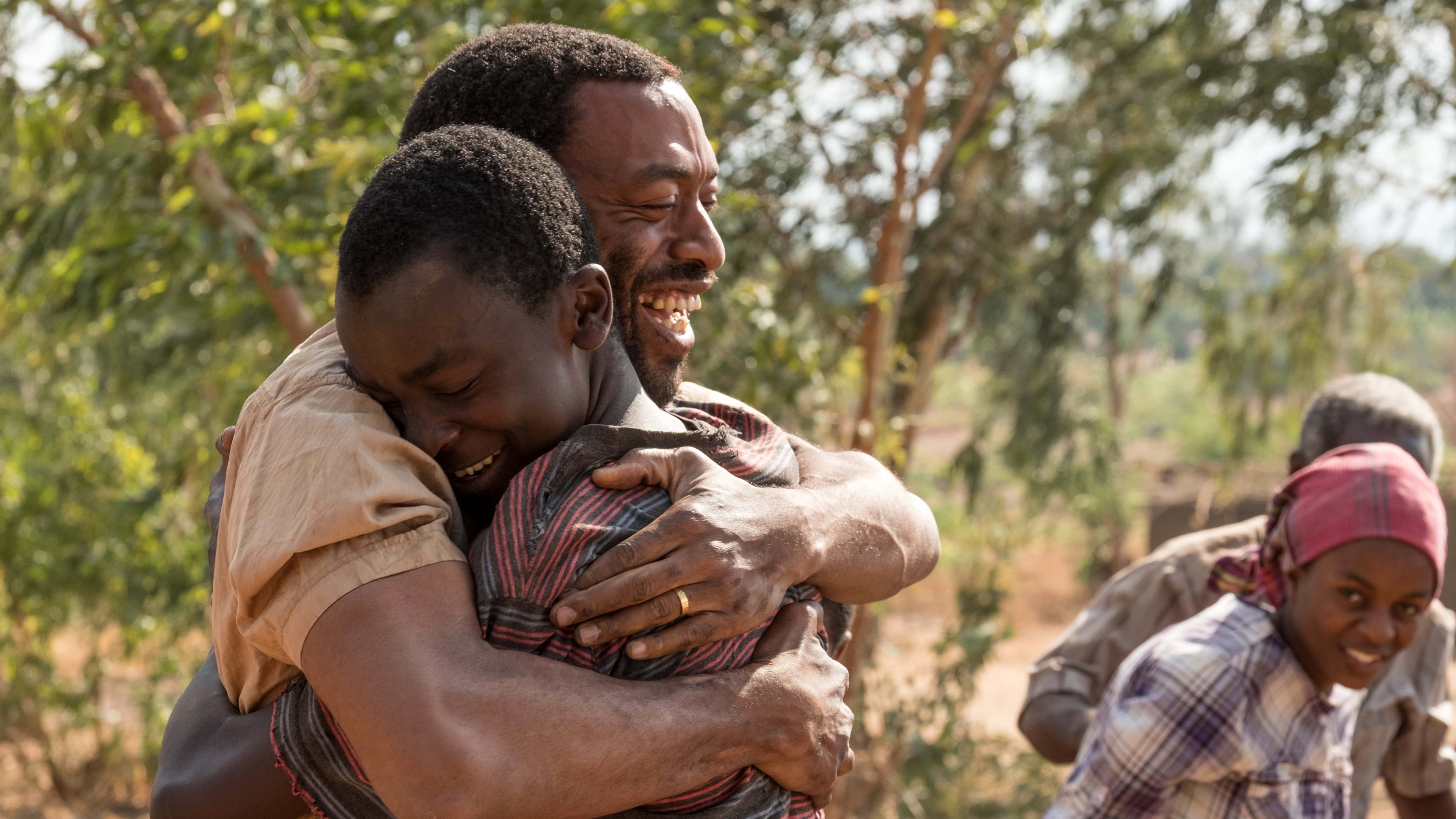 Chiwetel Ejiofor hugging a boy HD Wallpaper