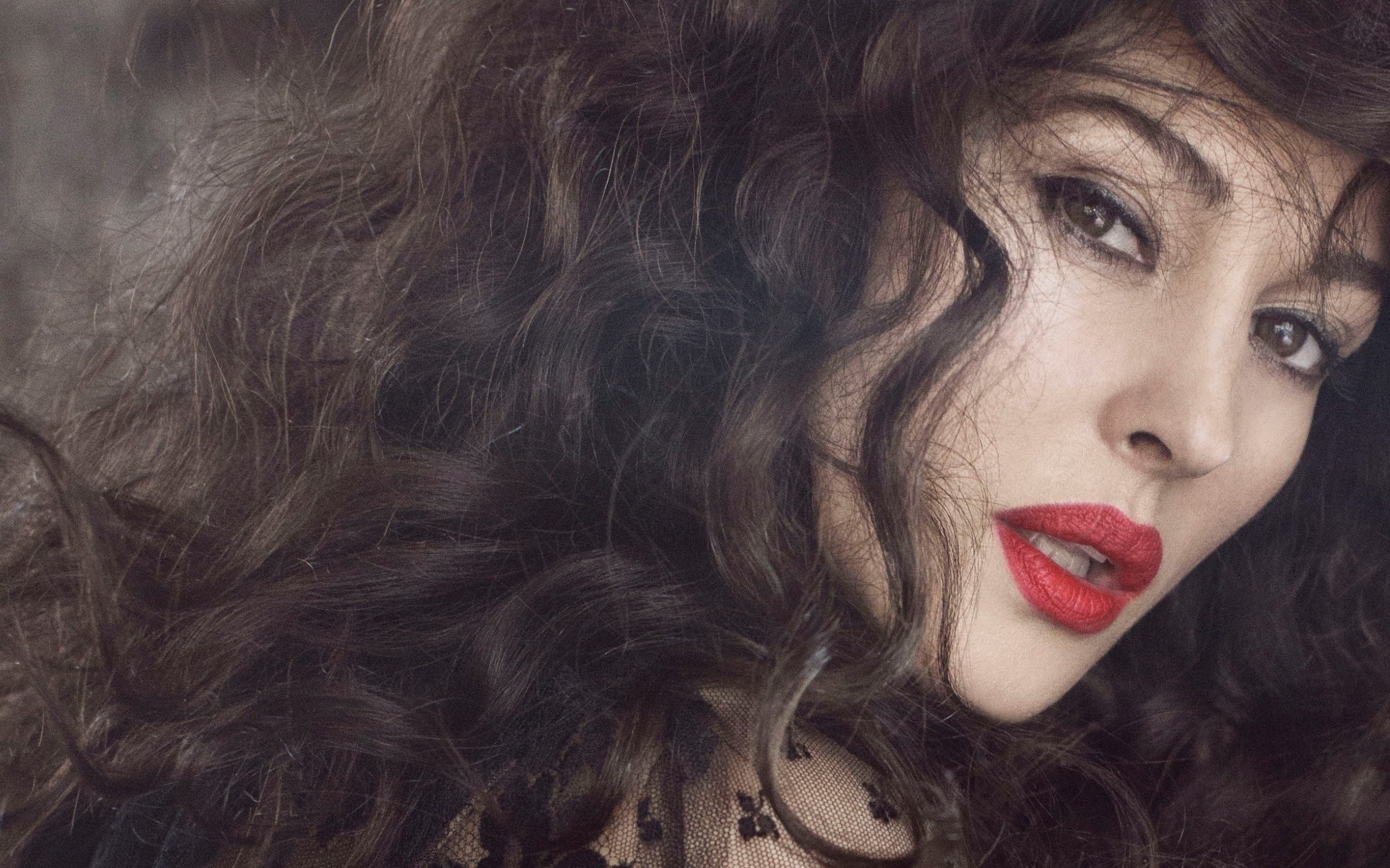 Monica Bellucci with dark curly hair and red lipstick HD Wallpaper