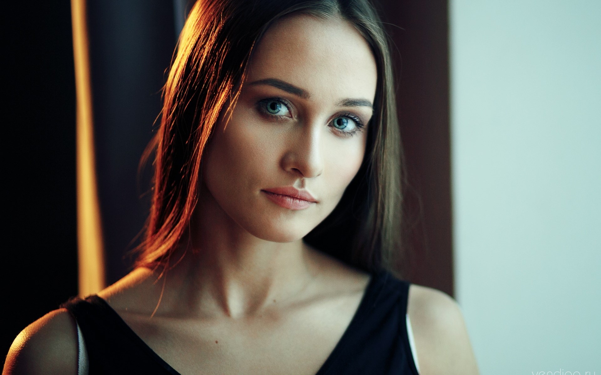 Woman with blue eyes and dark top HD Wallpaper