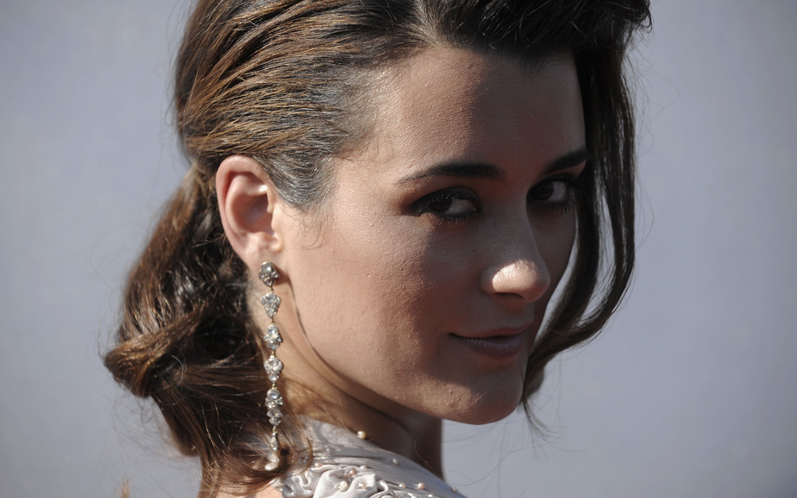 Woman with long earrings and styled hair HD Wallpaper