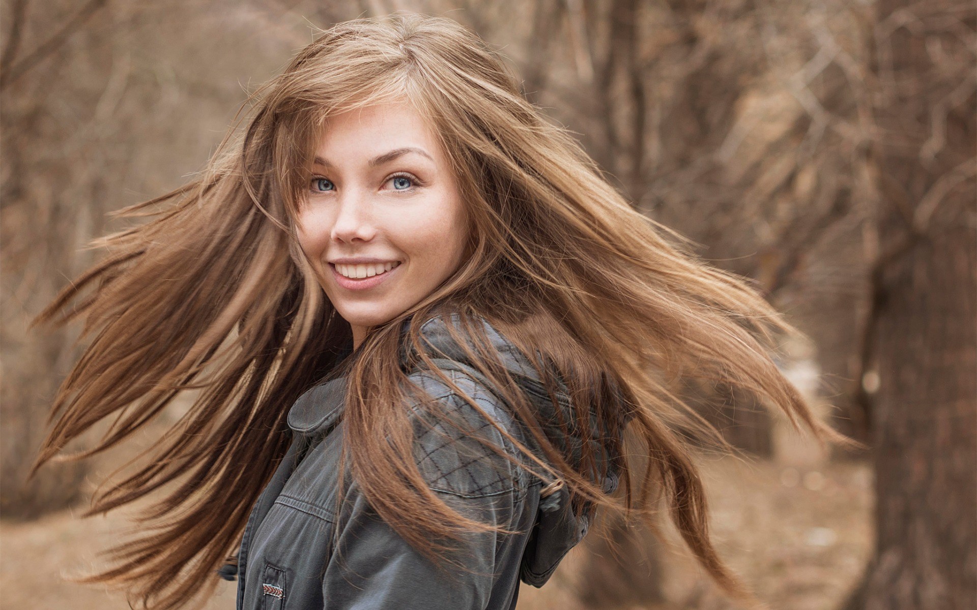 Young woman with long brown hair outdoors HD Wallpaper