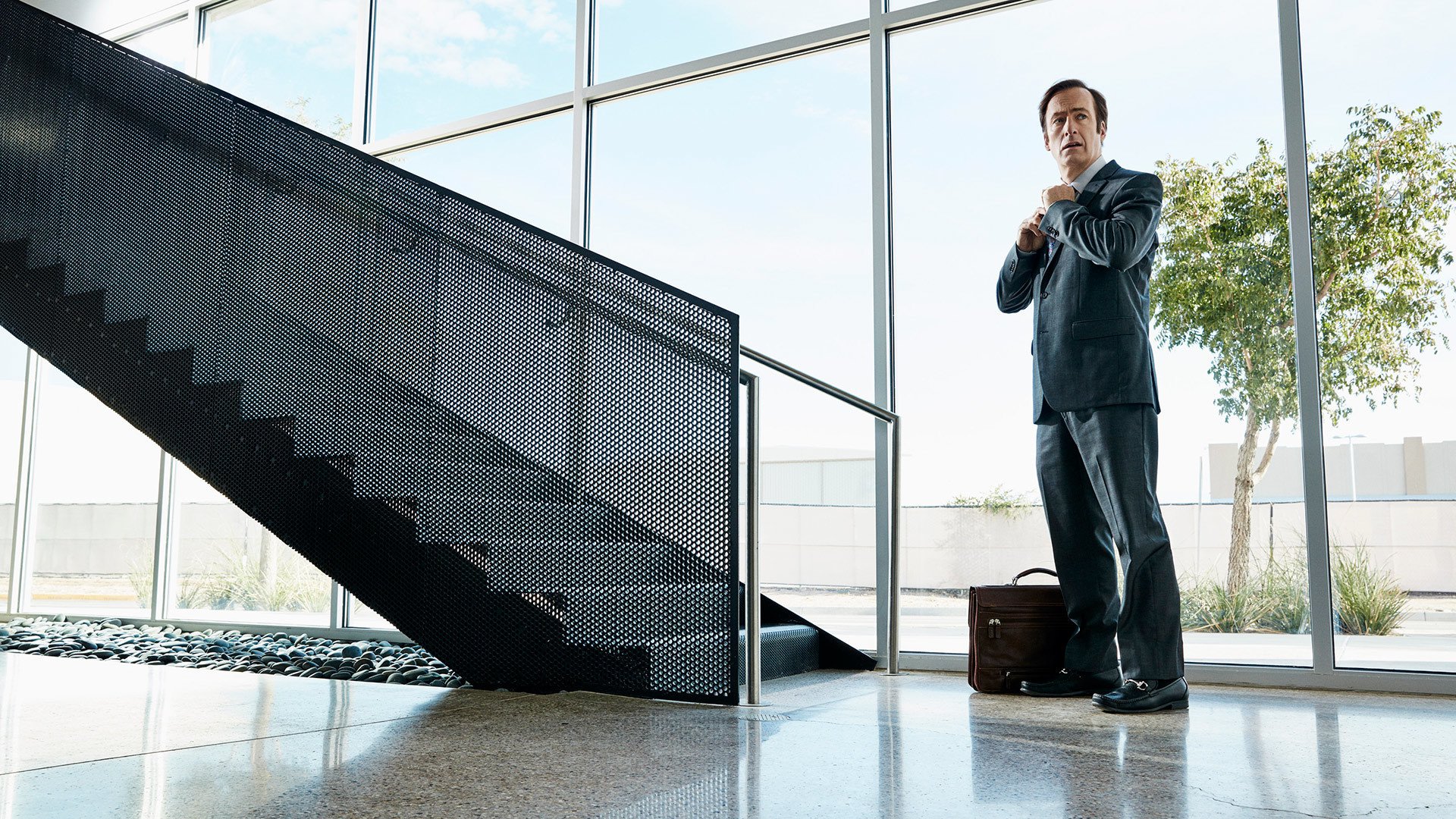 Bob Odenkirk in a suit adjusting his tie HD Wallpaper