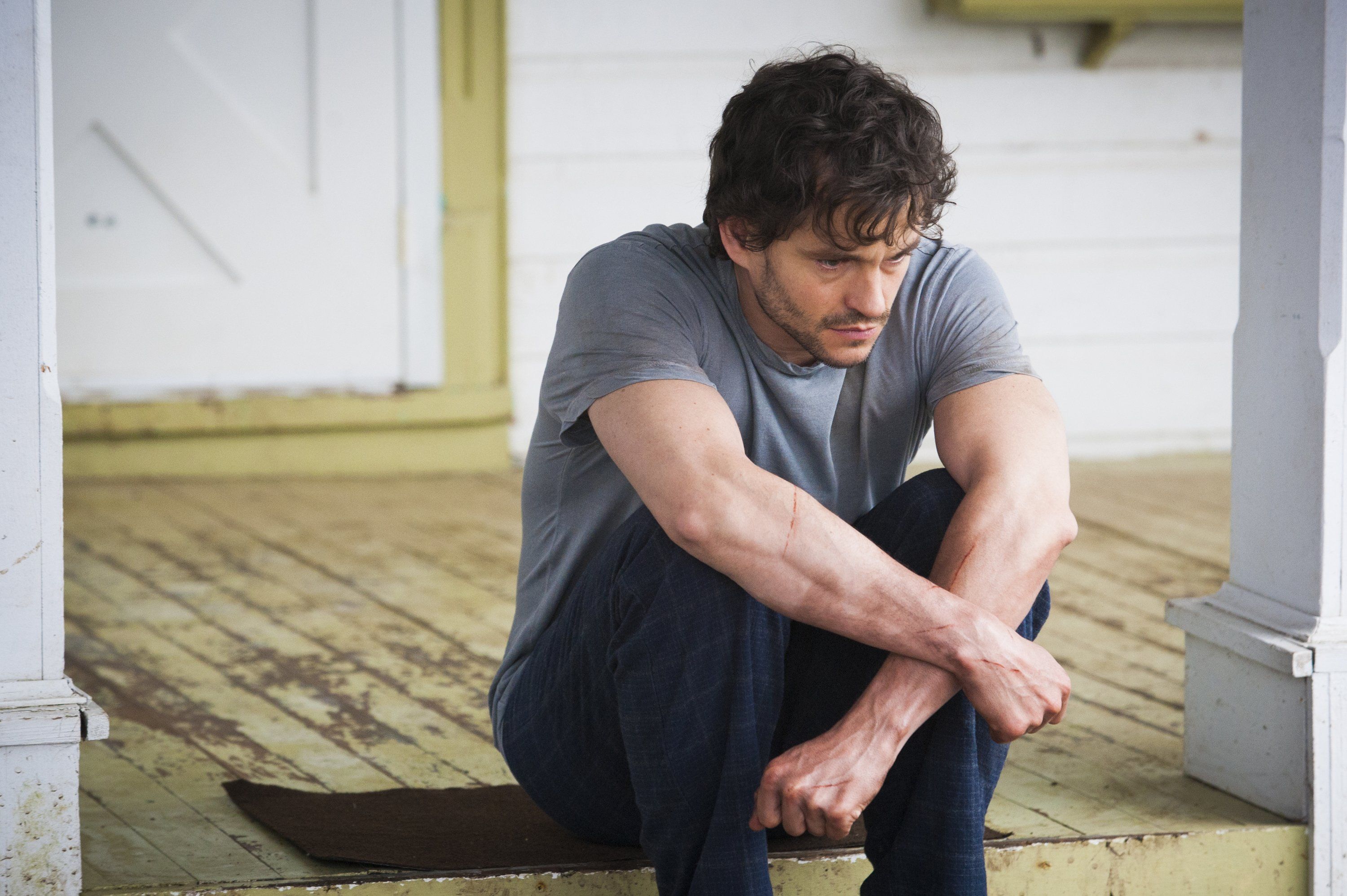 Hugh Dancy sitting on a porch HD Wallpaper