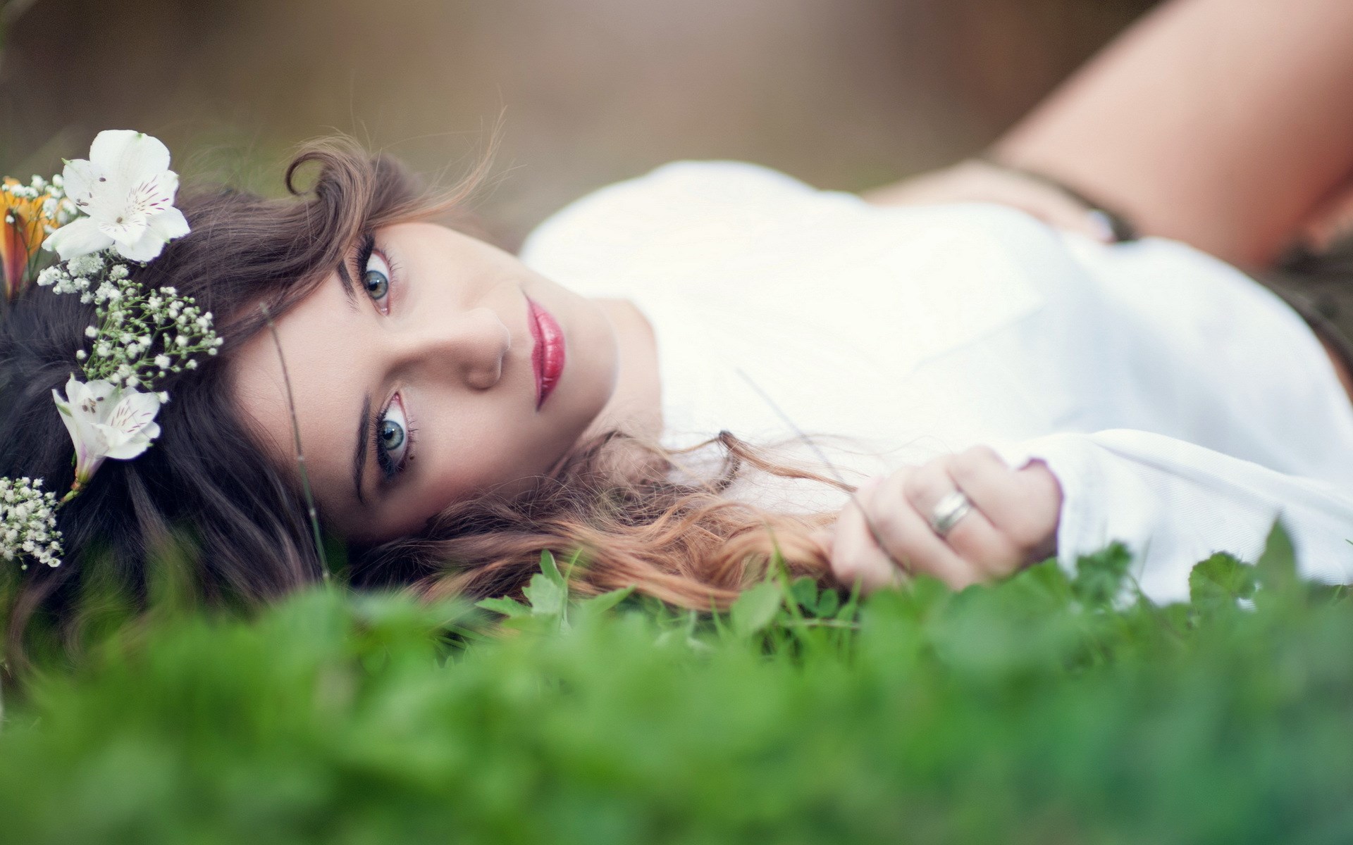 Woman with flower crown lying in grass HD Wallpaper