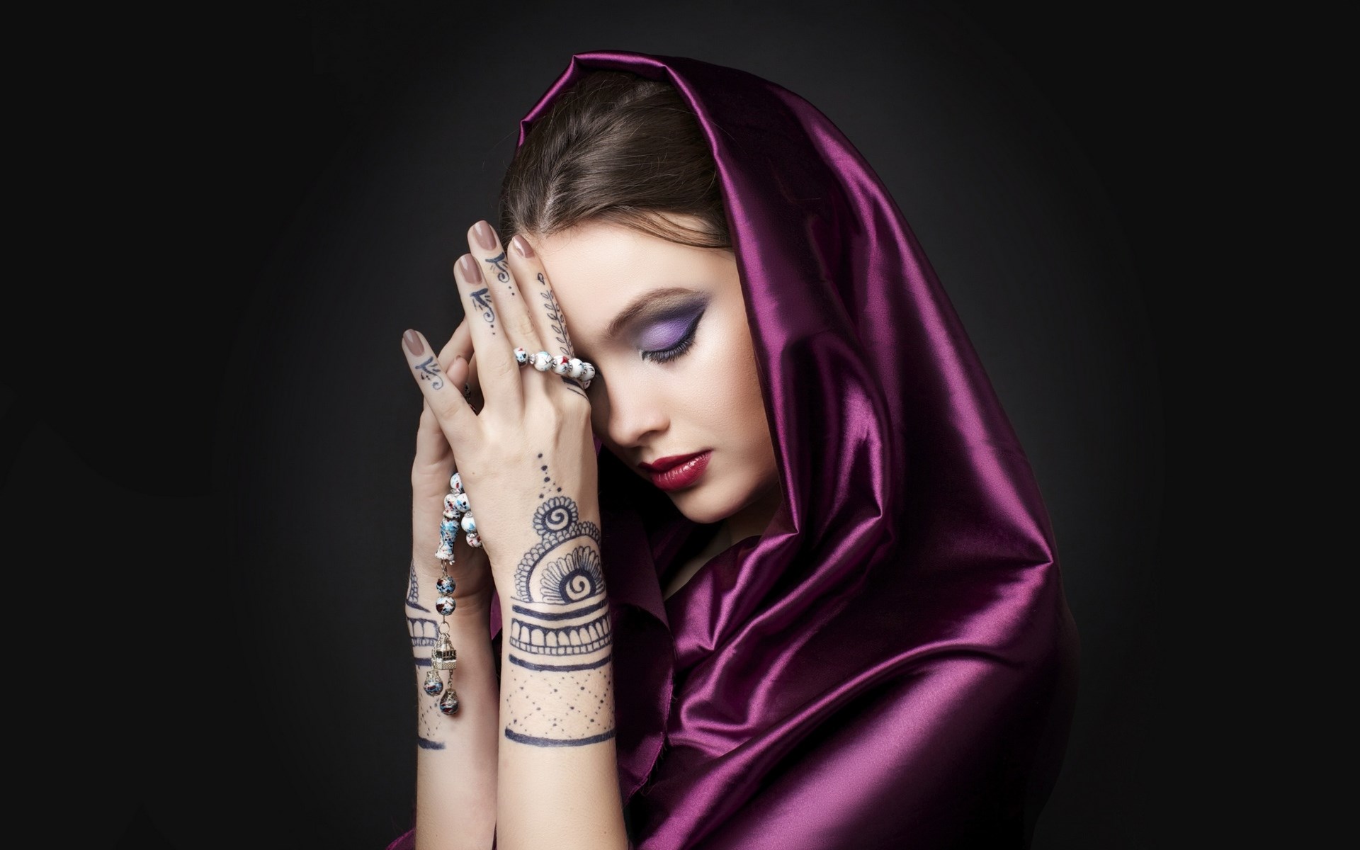 Woman with henna tattoos and purple headscarf HD Wallpaper