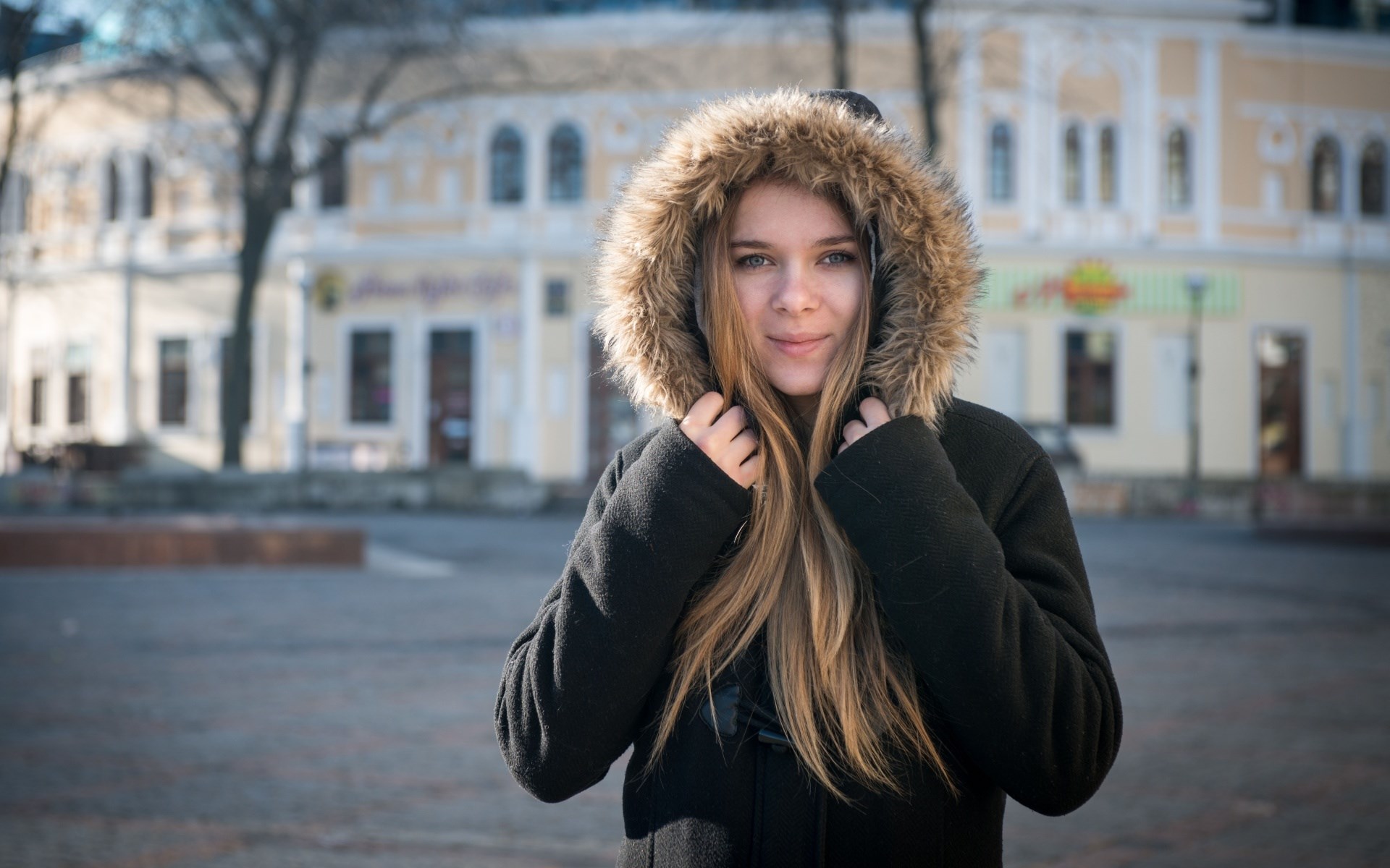 Young woman in a fur-hooded coat HD Wallpaper