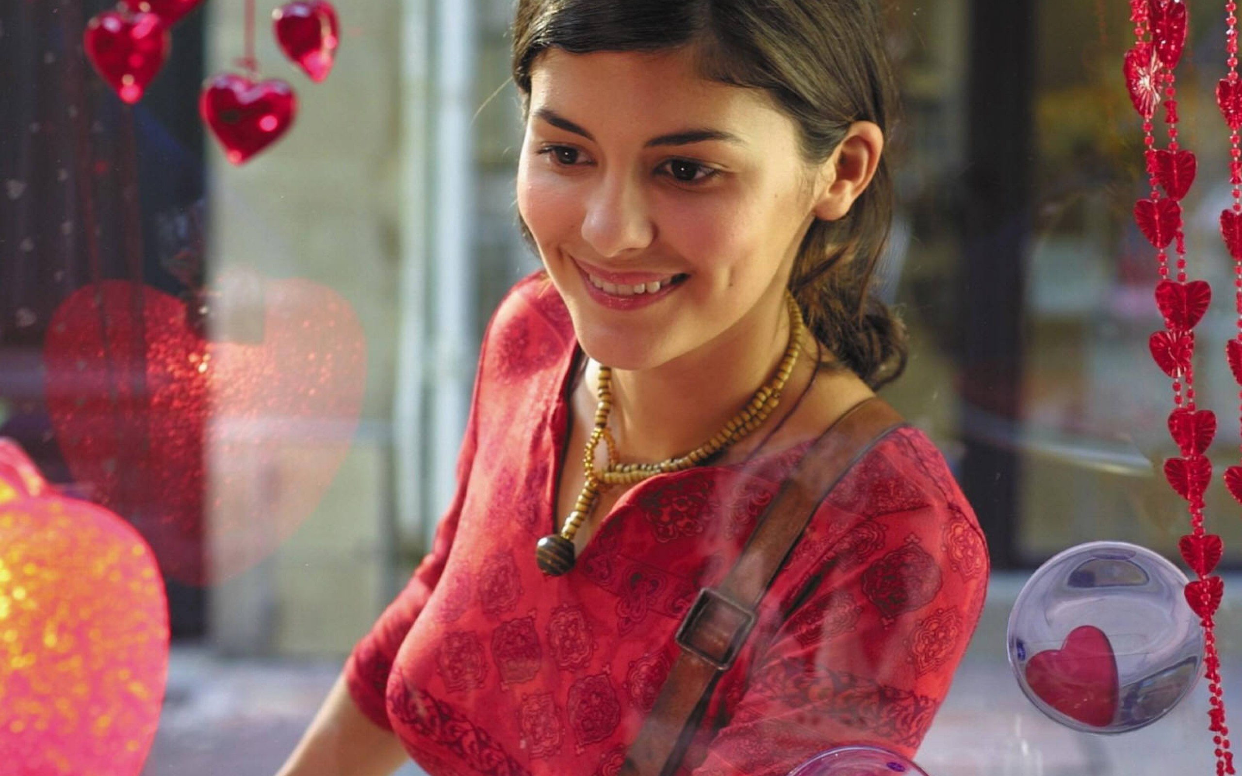Audrey Tautou smiling with heart decorations HD Wallpaper