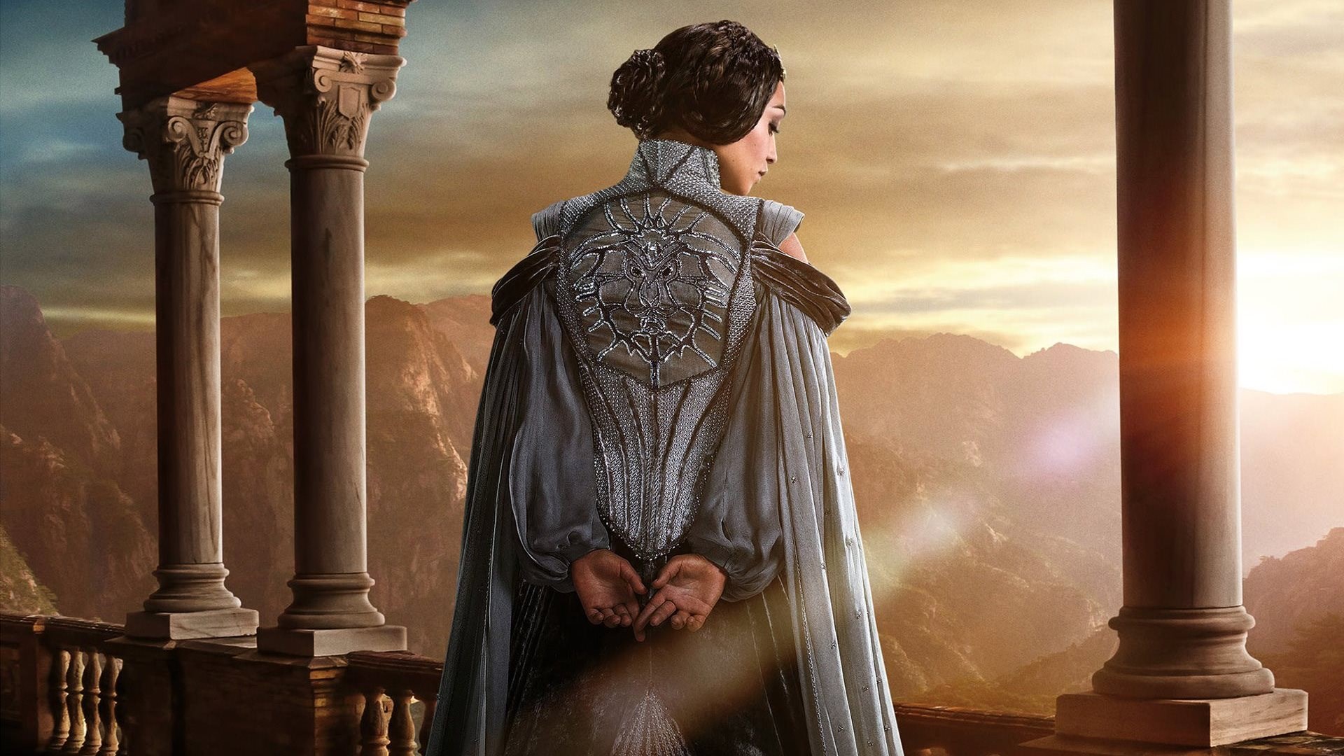 Woman in ornate dress on balcony overlooking mountains HD Wallpaper