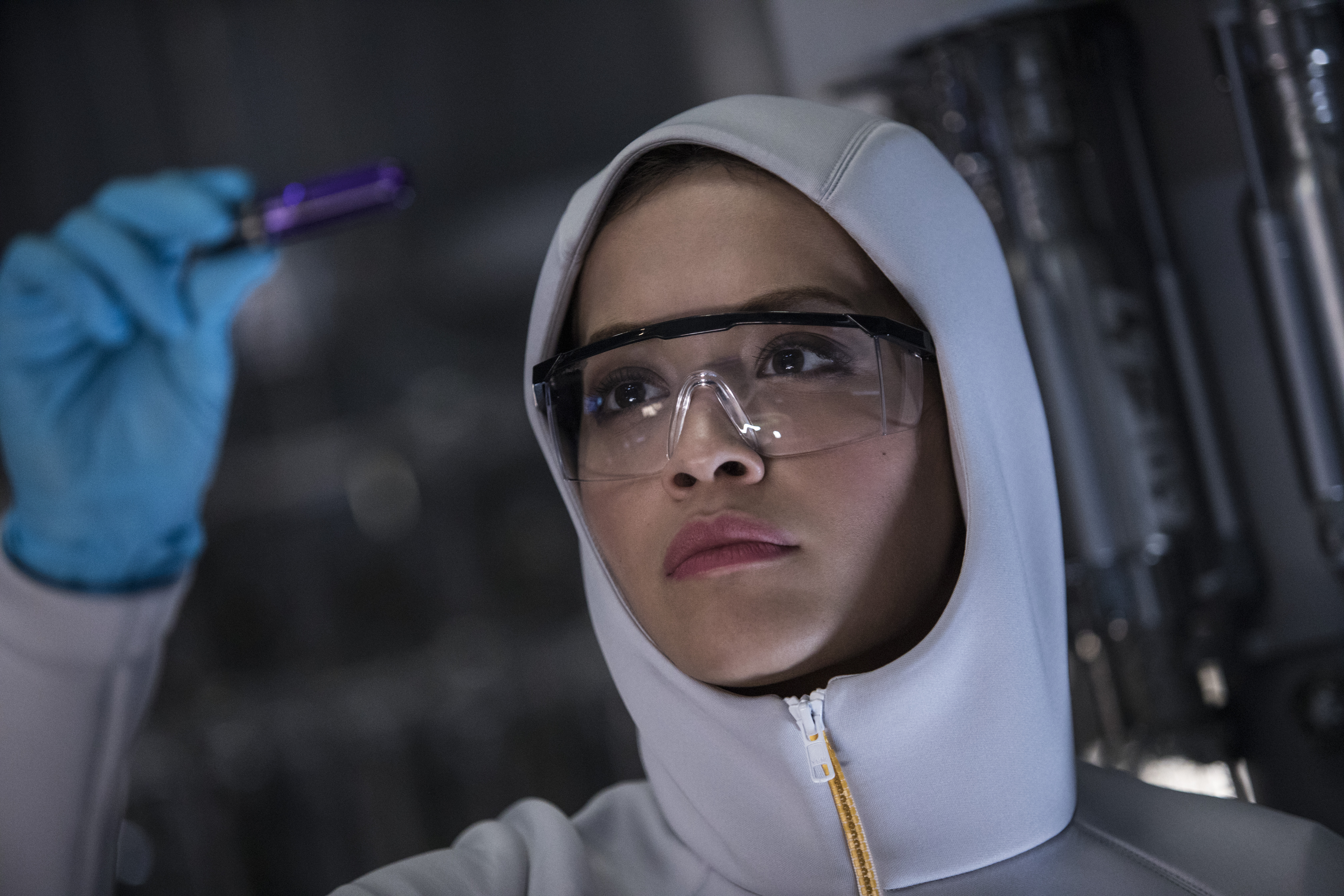 Rita Ora in protective gear holding a vial HD Wallpaper