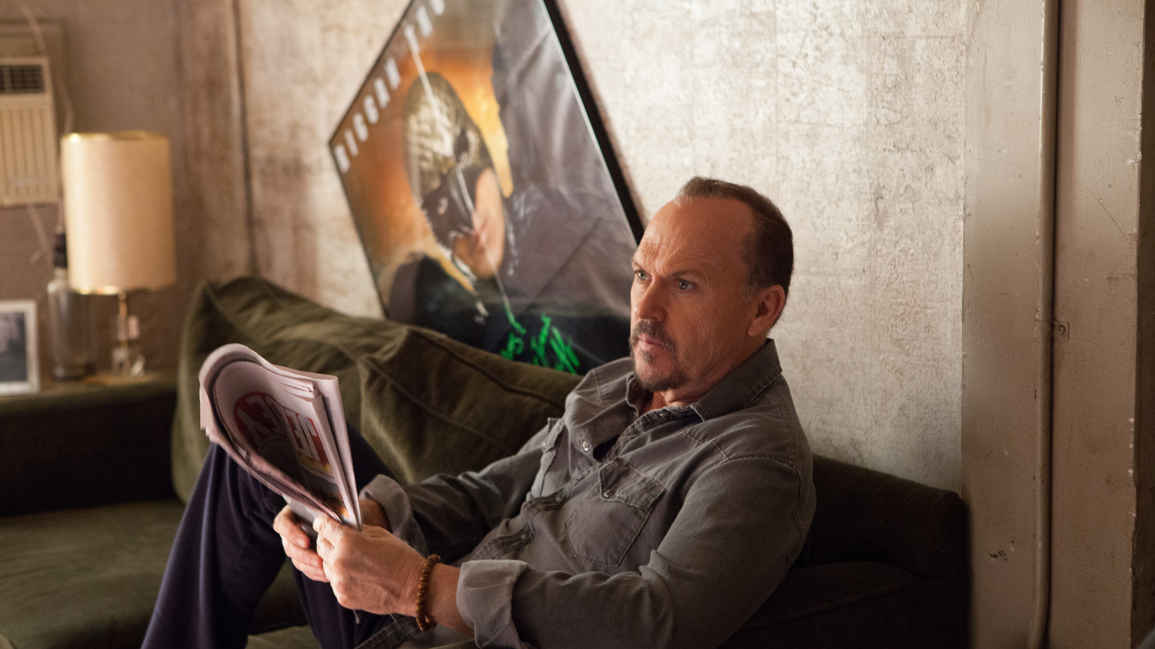 Michael Keaton reading a magazine on a couch HD Wallpaper
