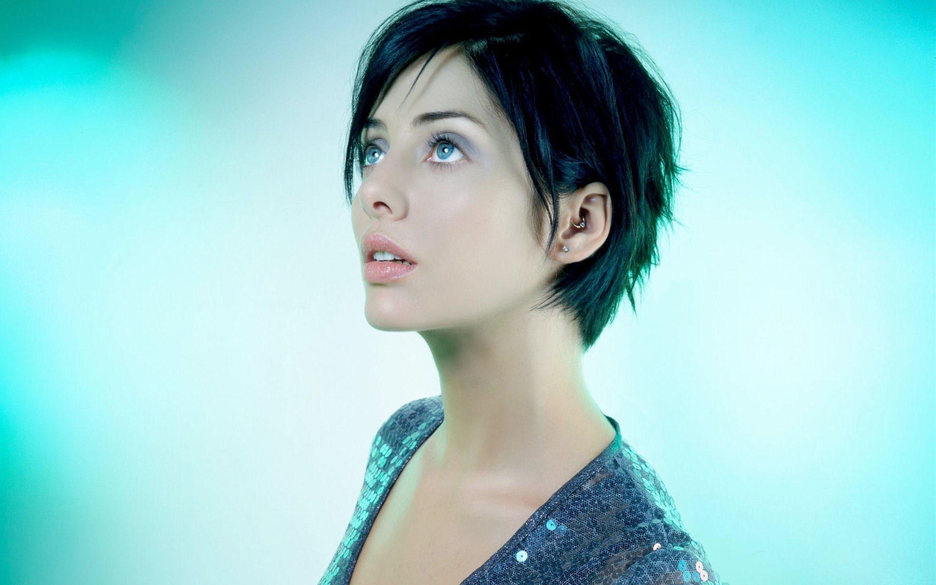 Woman with short black hair and blue eyes looking up HD Wallpaper