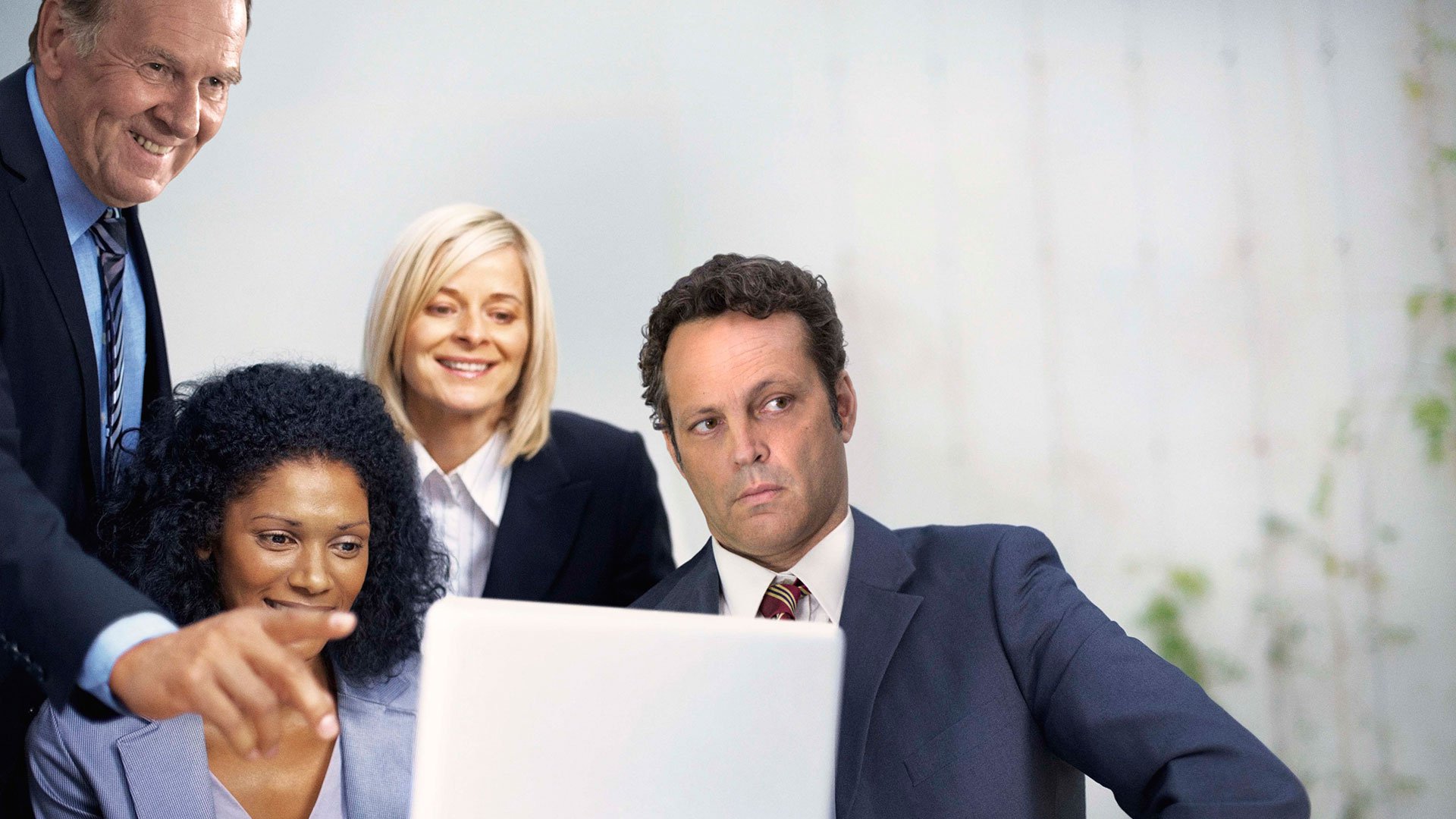 Vince Vaughn and colleagues looking at a laptop HD Wallpaper