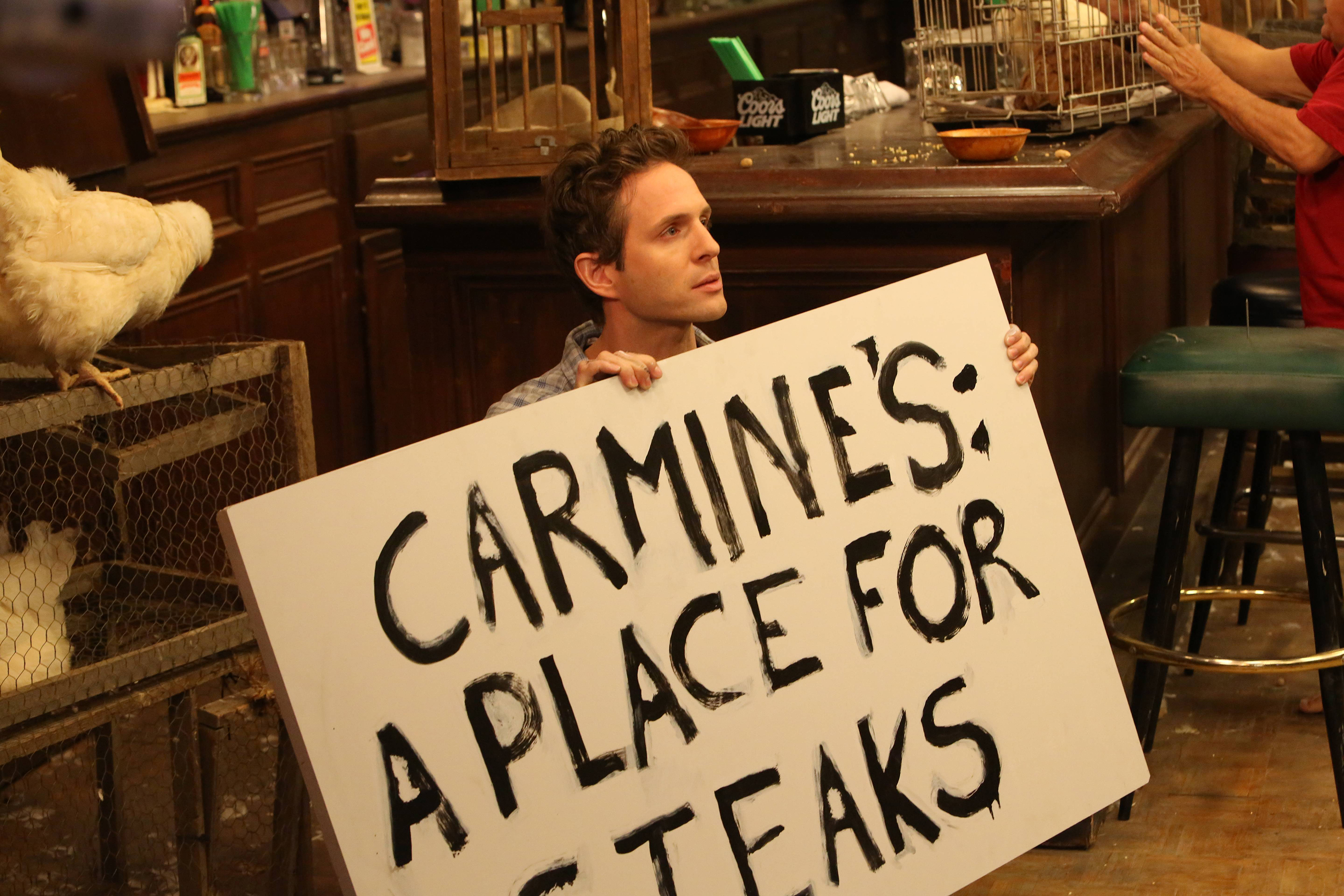 Glenn Howerton holding a sign with chickens HD Wallpaper