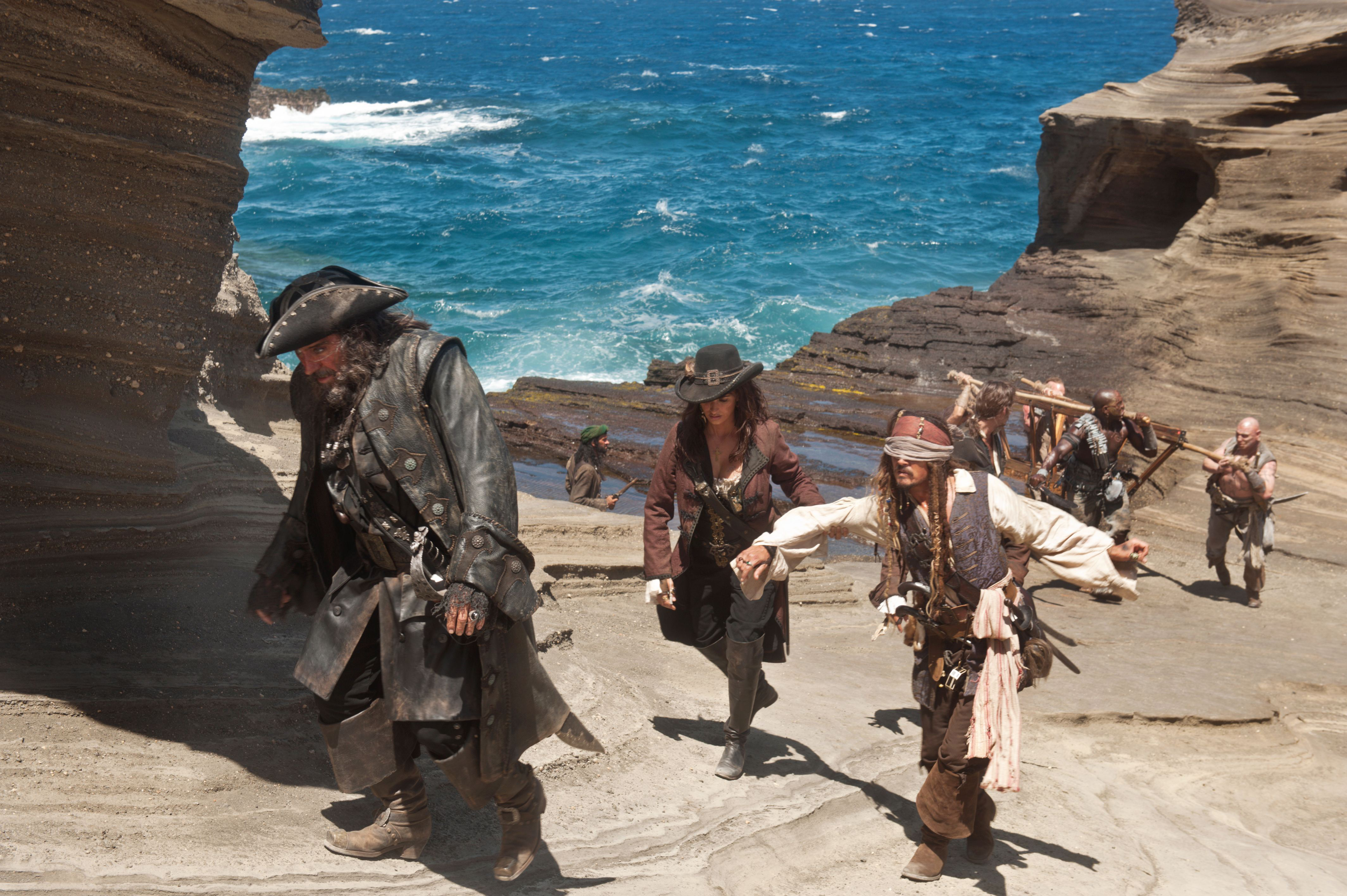 Pirates walking on a rocky shore HD Wallpaper