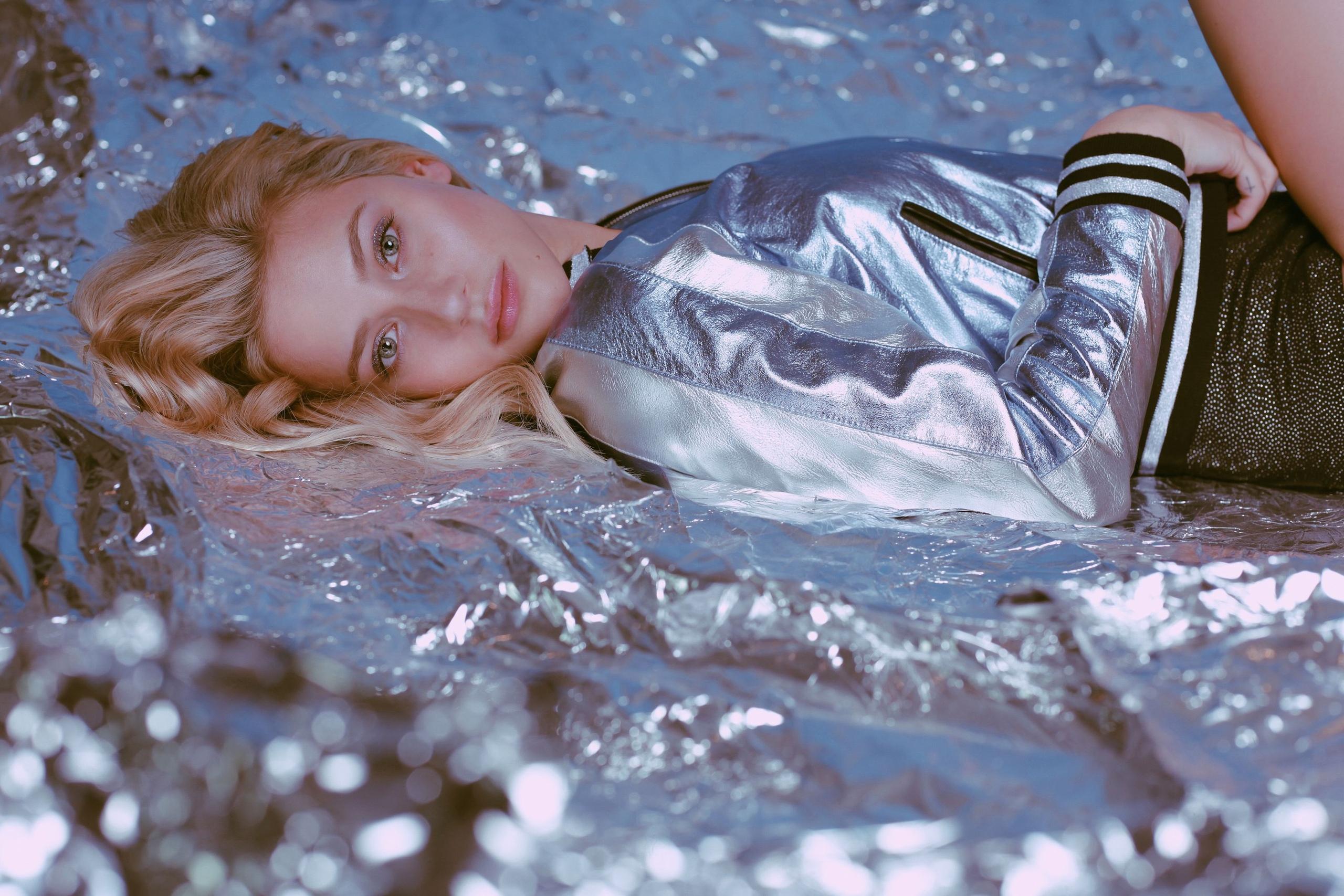 Lili Reinhart lying on metallic material HD Wallpaper