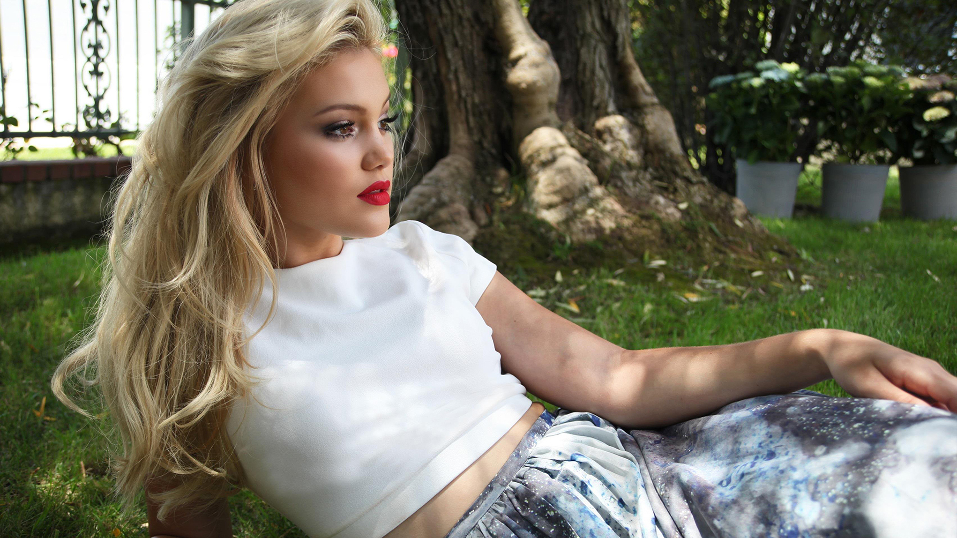 Olivia Holt in a garden HD Wallpaper