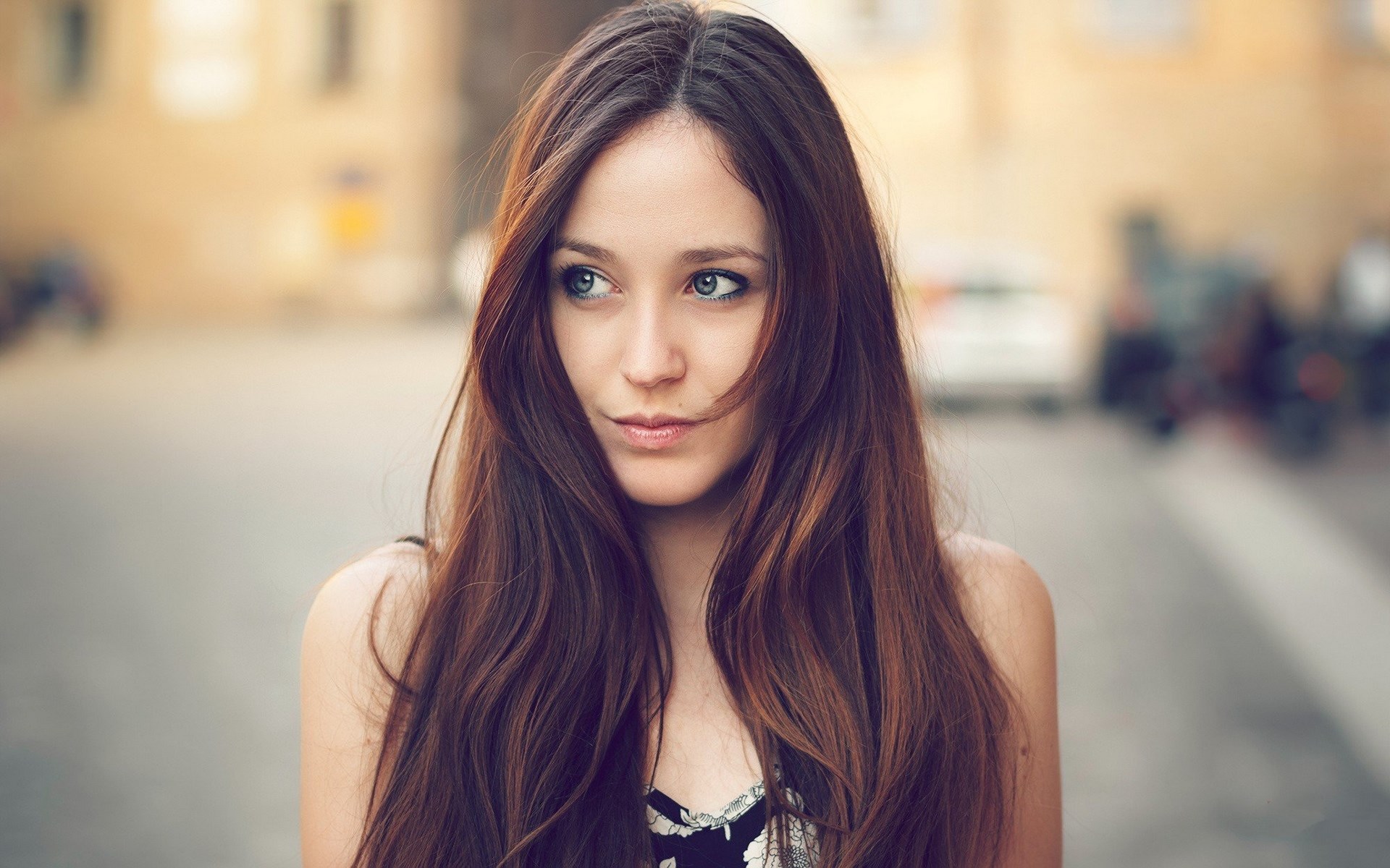 Woman with long brown hair looking to the side HD Wallpaper