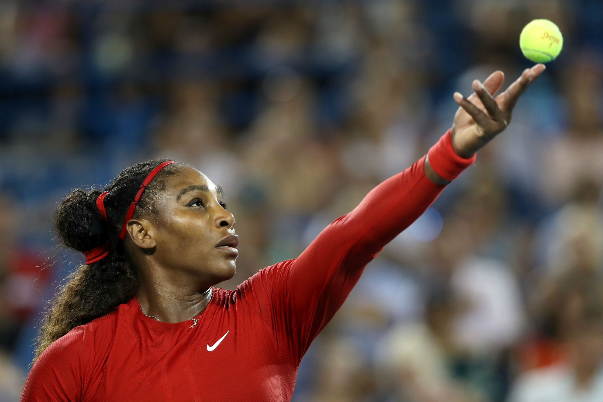 Serena Williams serving a tennis ball HD Wallpaper