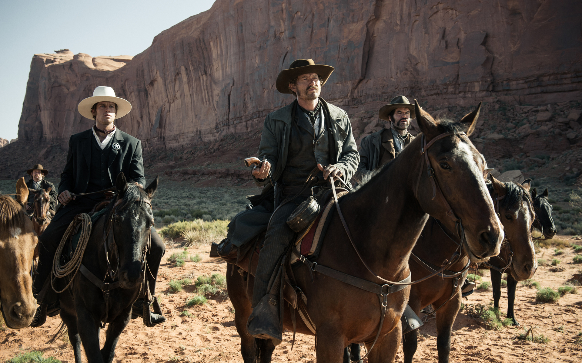 Men on horseback in a desert landscape HD Wallpaper