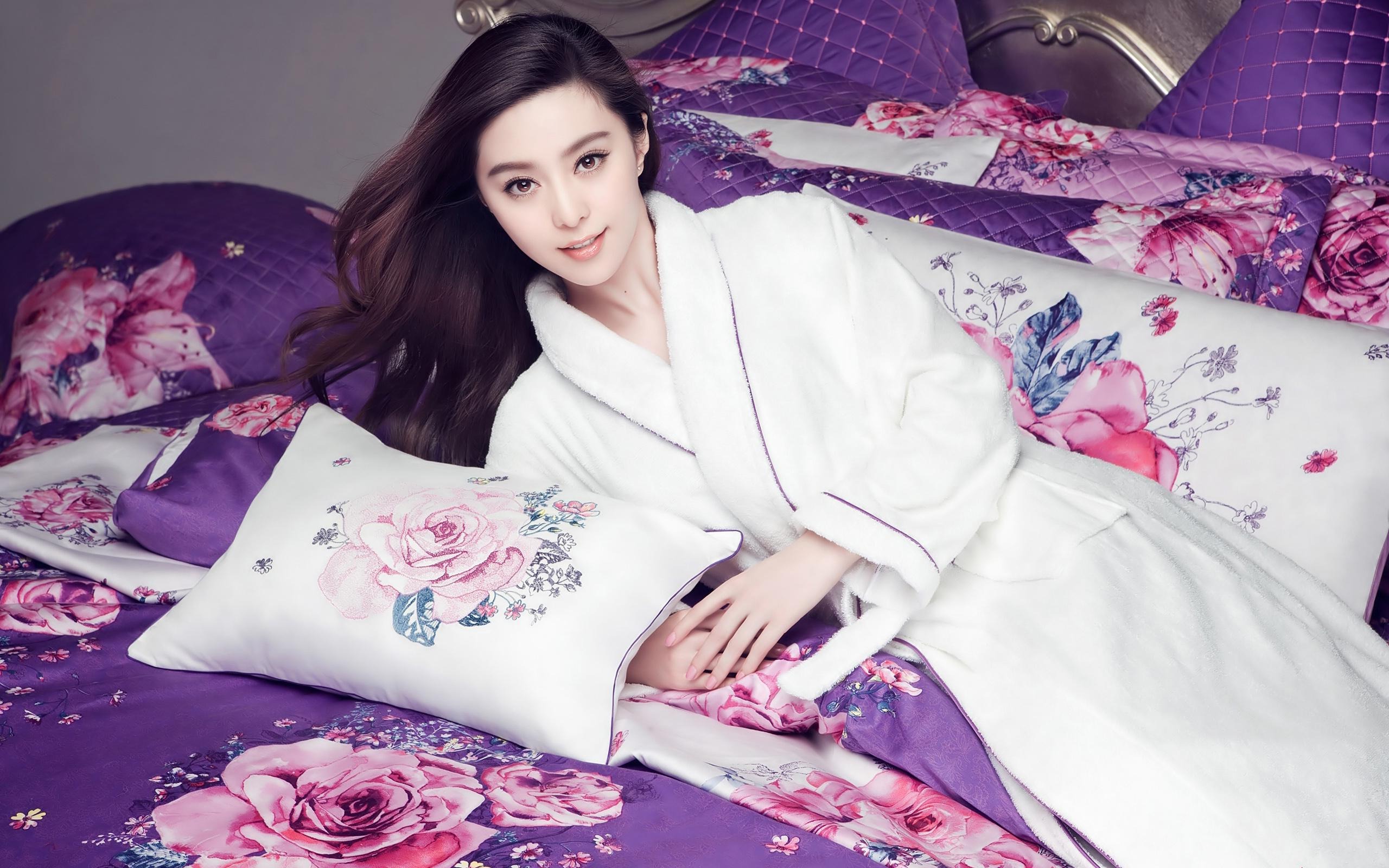 Fan Bingbing in a white robe on a floral bed HD Wallpaper
