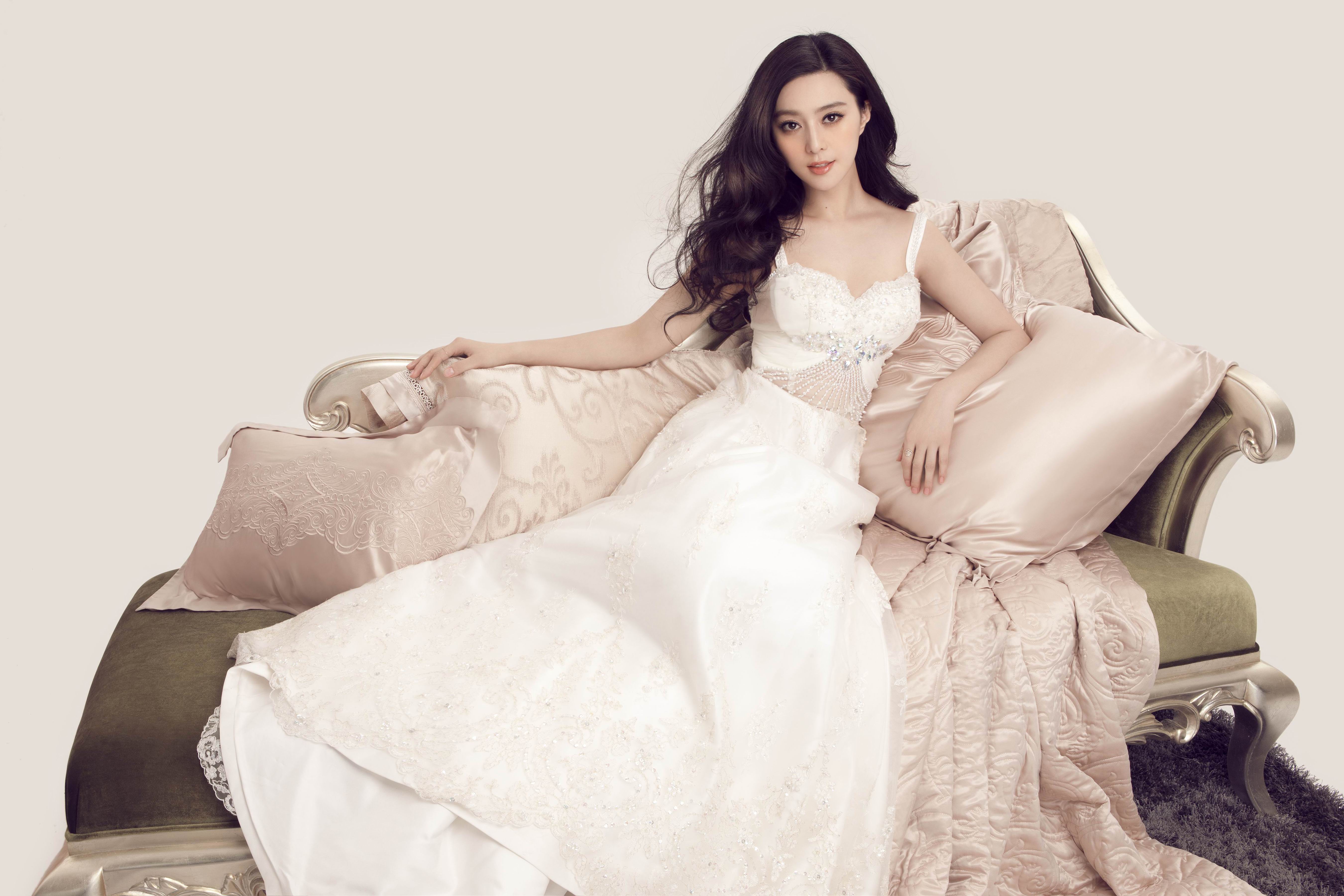 Fan Bingbing in a white dress on a couch HD Wallpaper