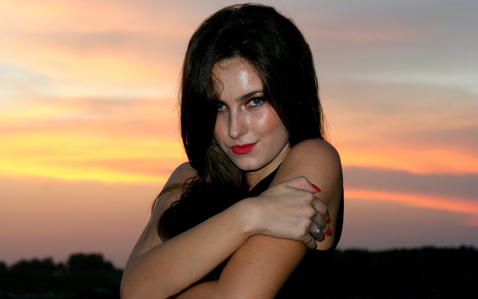 Woman with dark hair and red lipstick at sunset HD Wallpaper