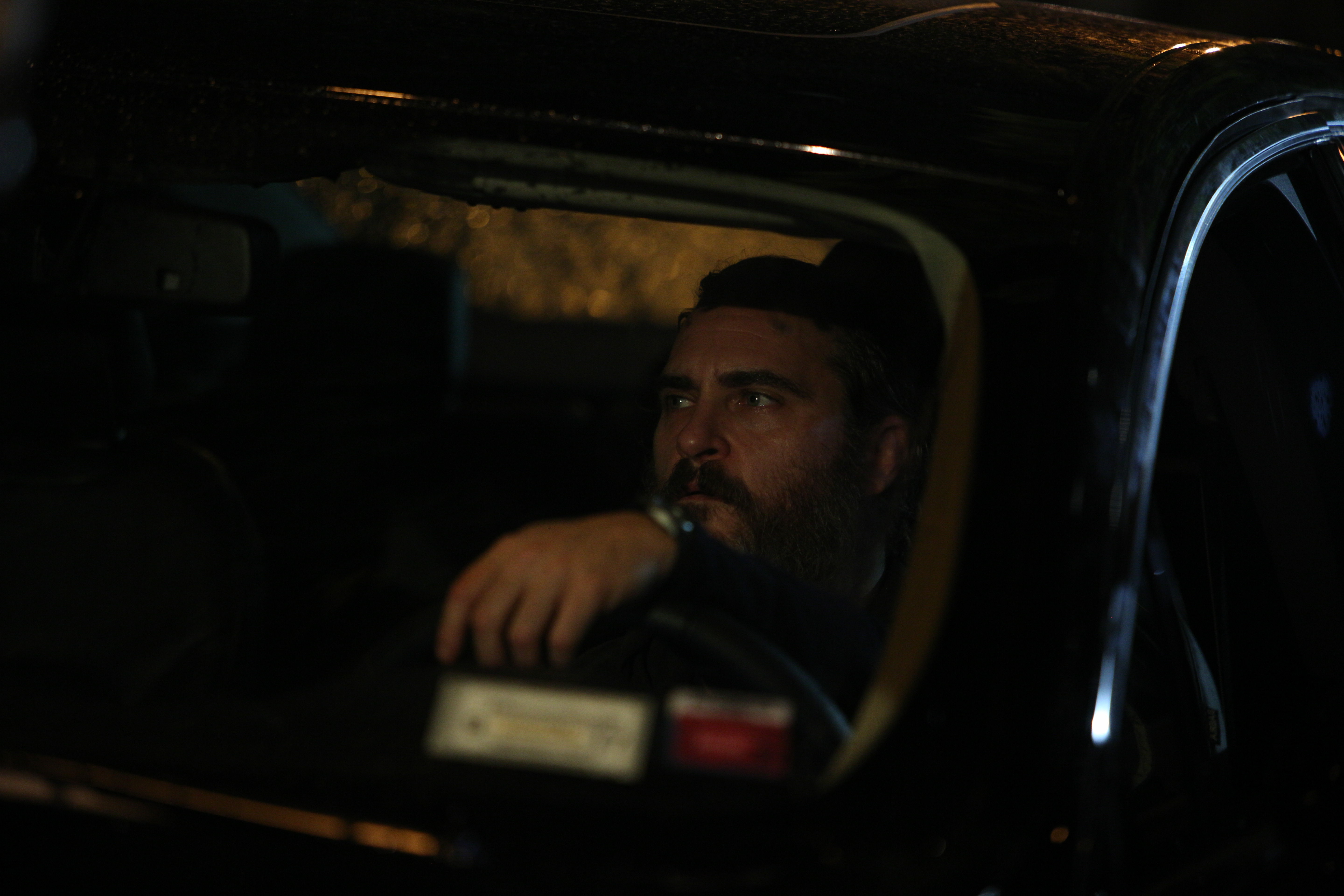 Joaquin Phoenix driving a car at night HD Wallpaper
