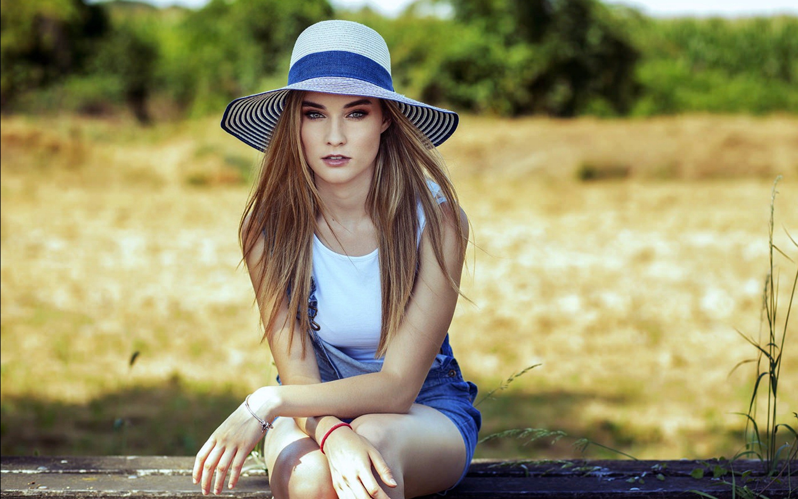Woman in a sun hat and denim overalls HD Wallpaper