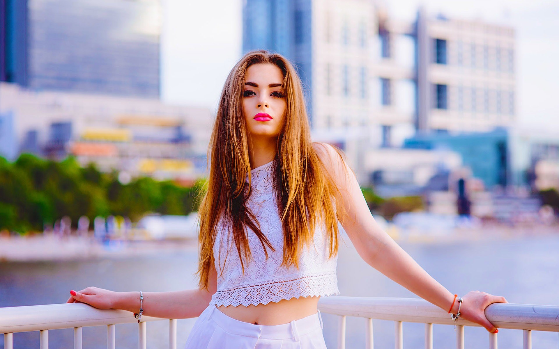Woman in white outfit leaning on railing HD Wallpaper