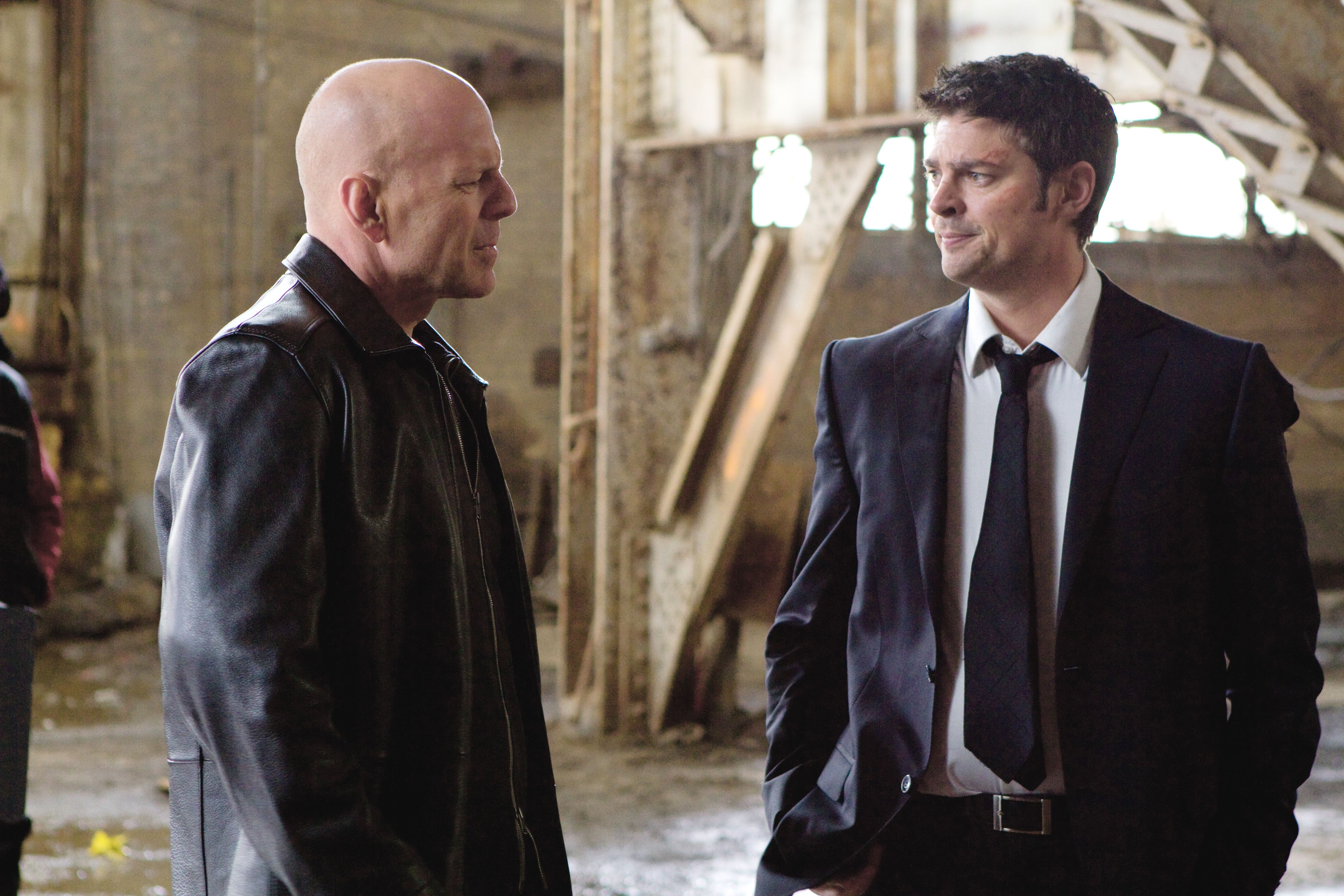 Bruce Willis and Karl Urban in an industrial setting HD Wallpaper