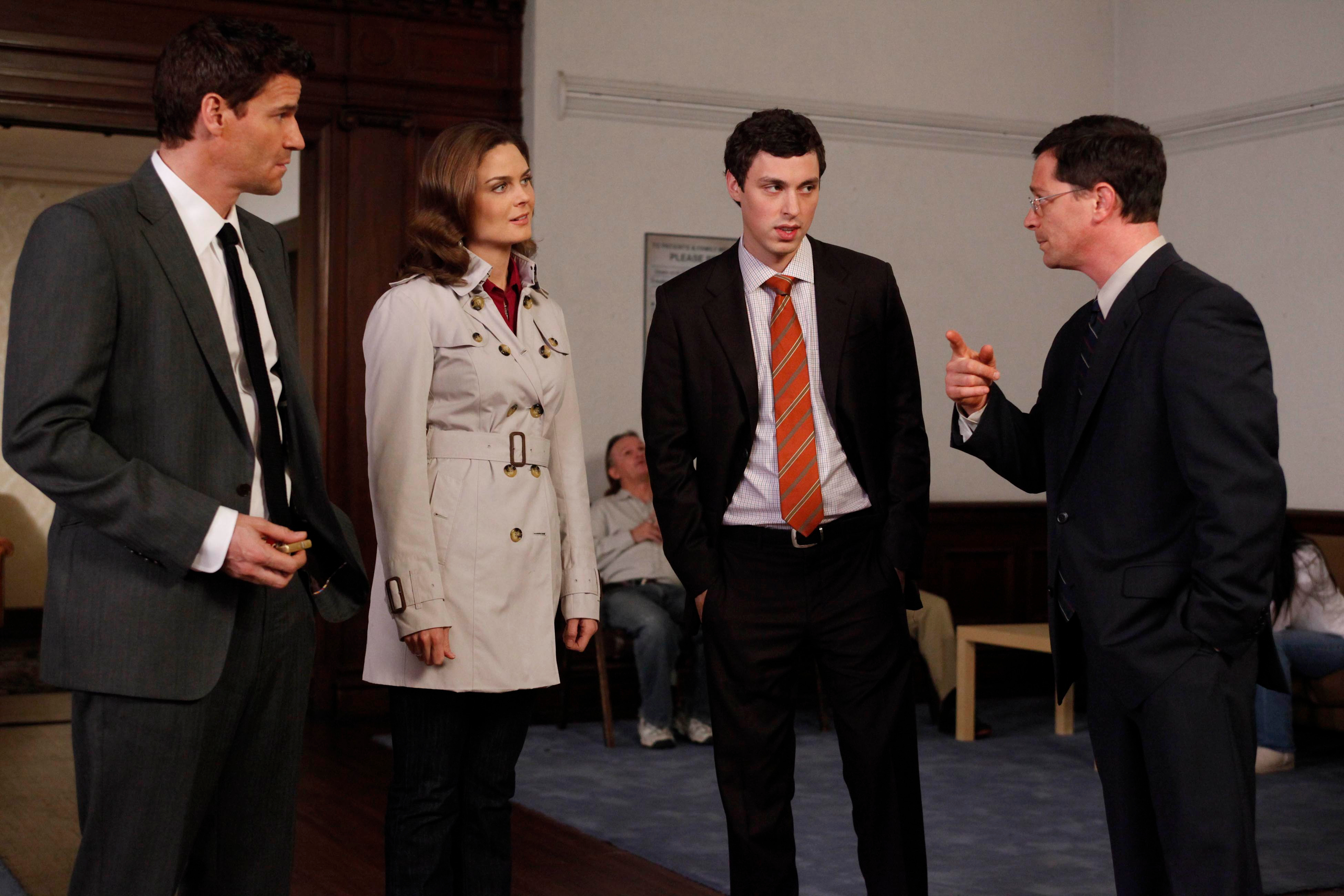Four people in suits in a room HD Wallpaper