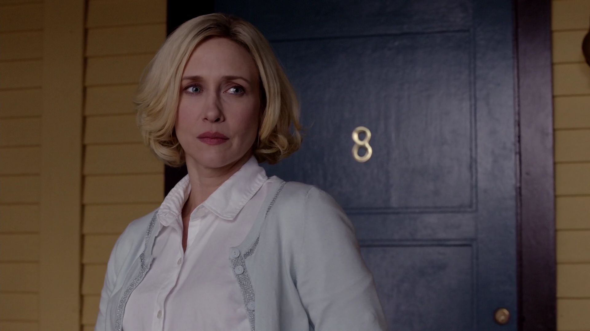Vera Farmiga standing by a blue door with number 8 HD Wallpaper