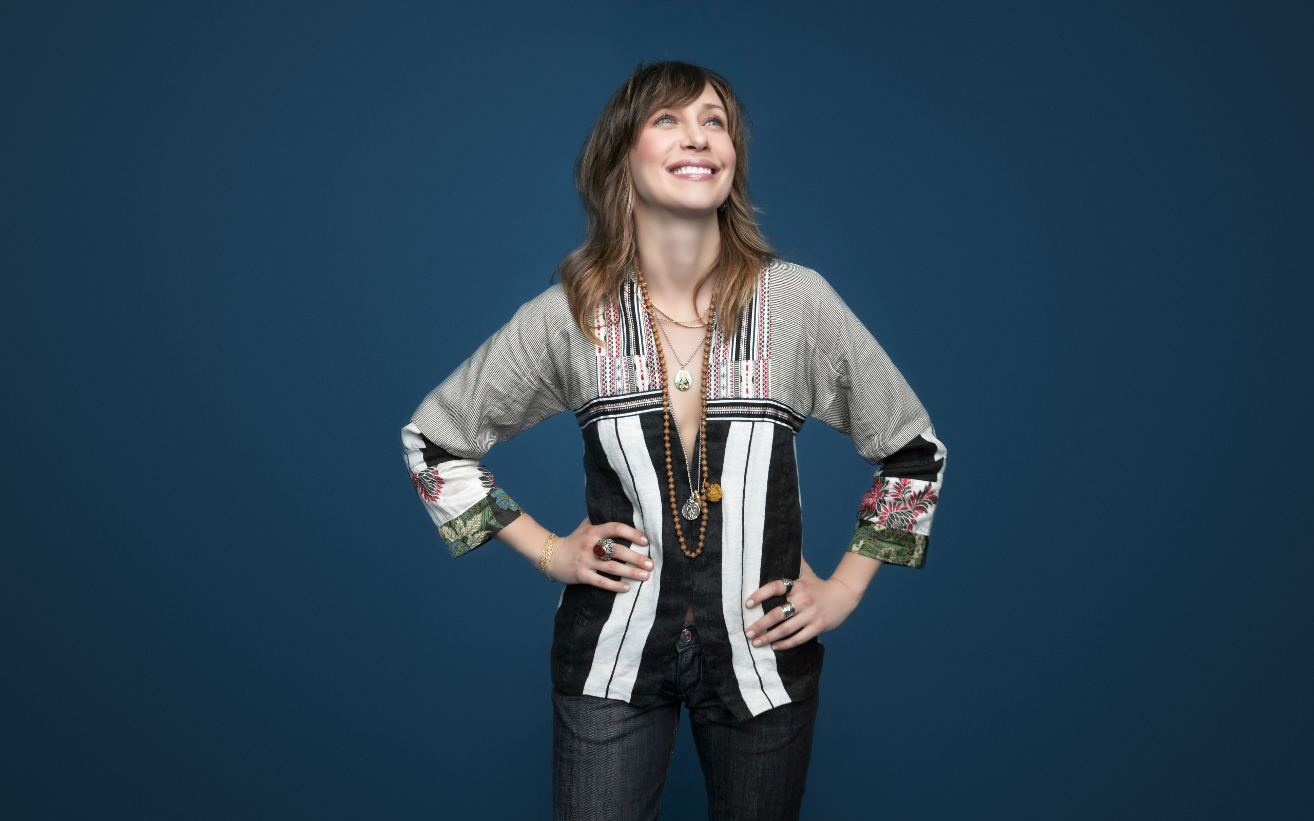 Vera Farmiga posing against a blue background HD Wallpaper