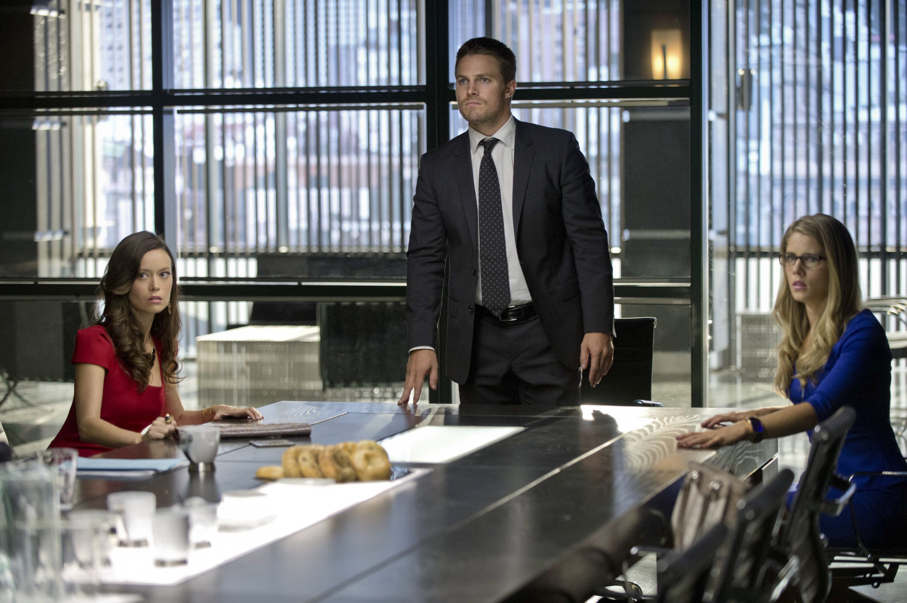 Emily Bett Rickards and two others in a boardroom HD Wallpaper