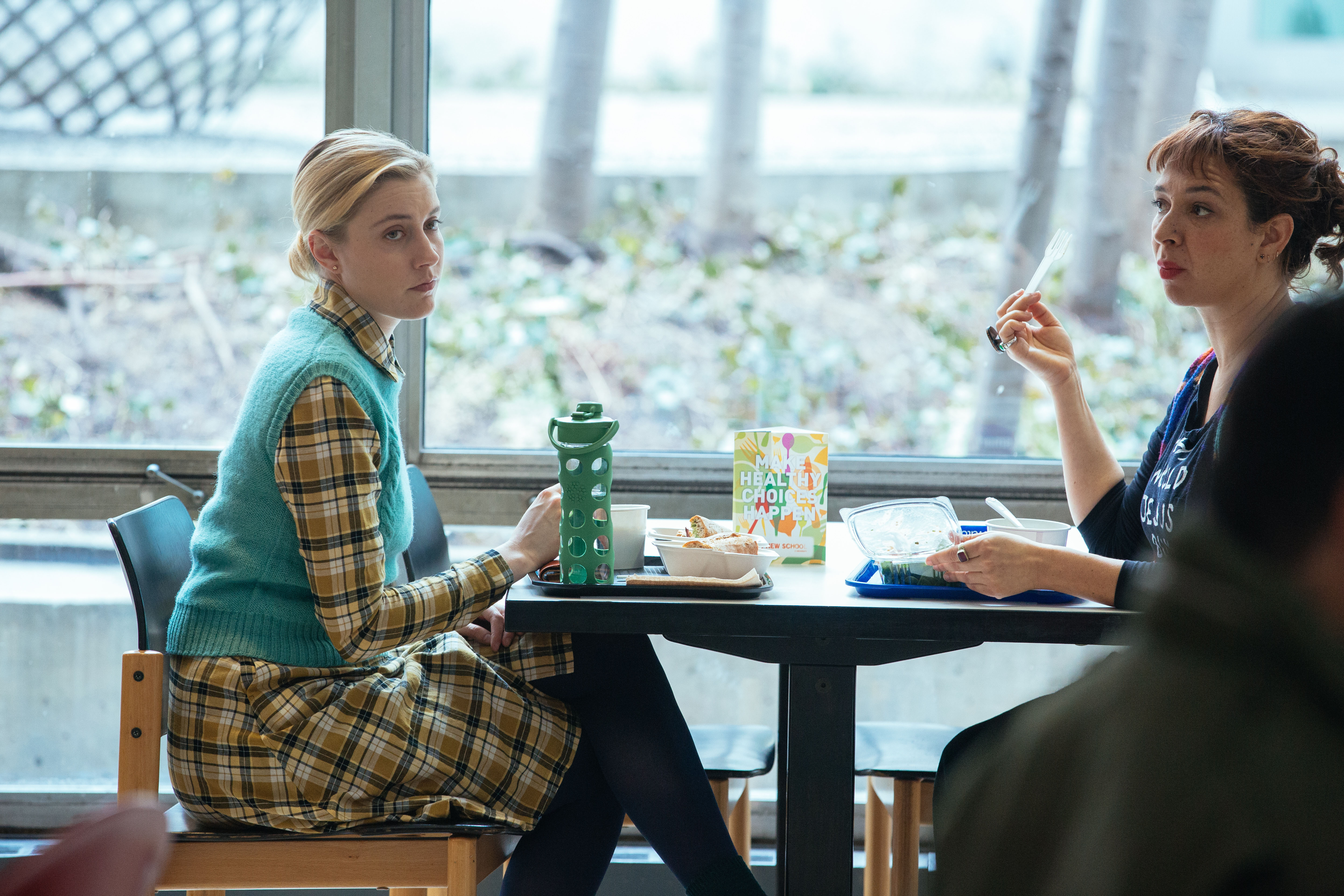Greta Gerwig in a cafeteria HD Wallpaper