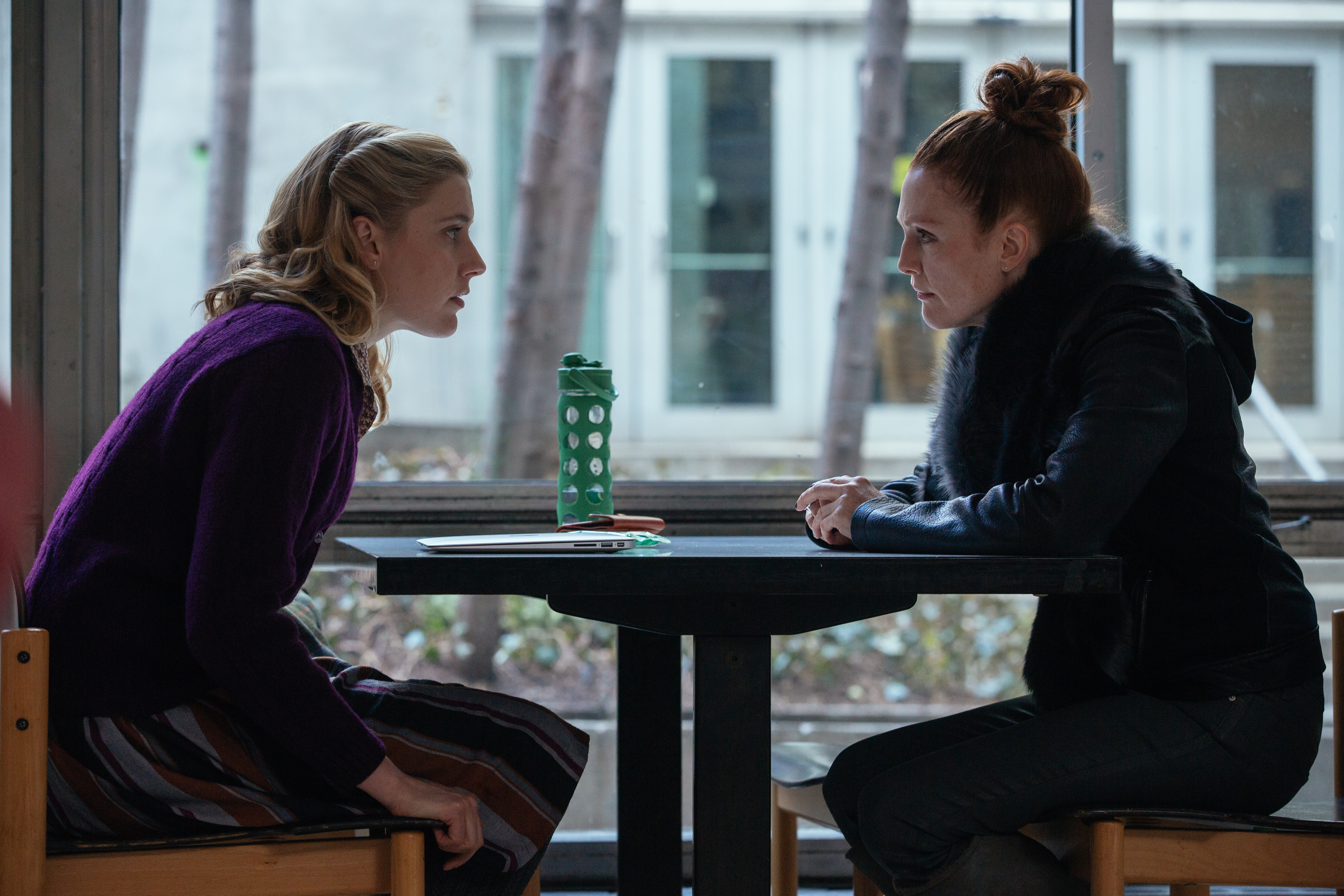 Greta Gerwig and woman sitting at table HD Wallpaper