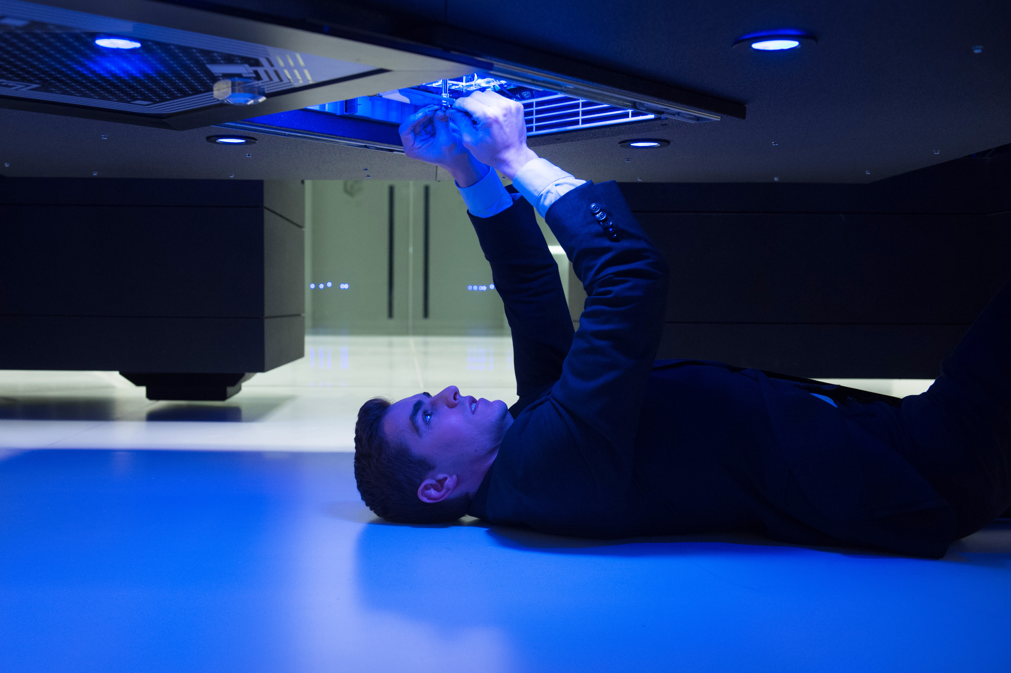 Dave Franco working on a futuristic console HD Wallpaper