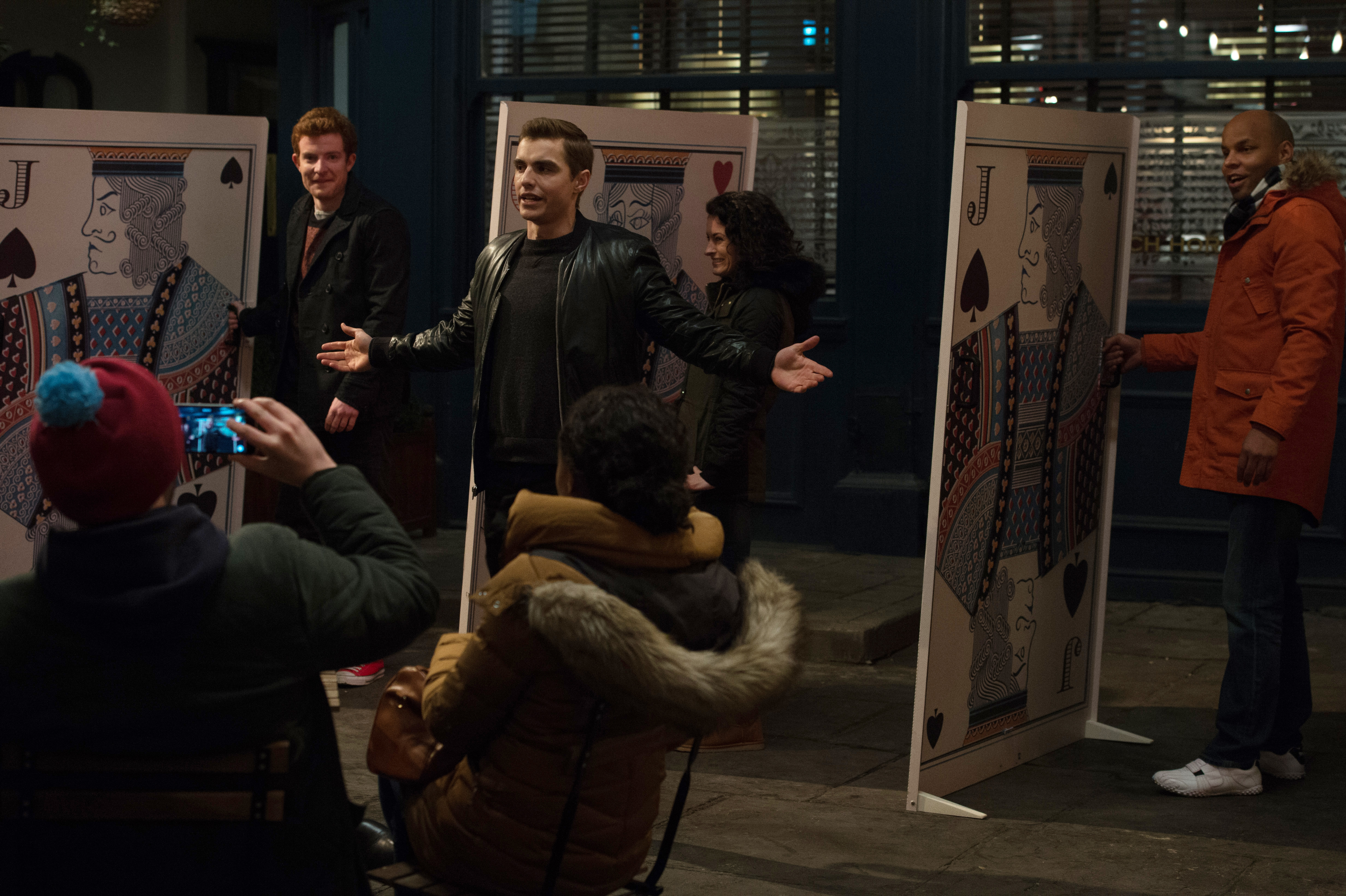 Dave Franco performing magic with giant cards HD Wallpaper