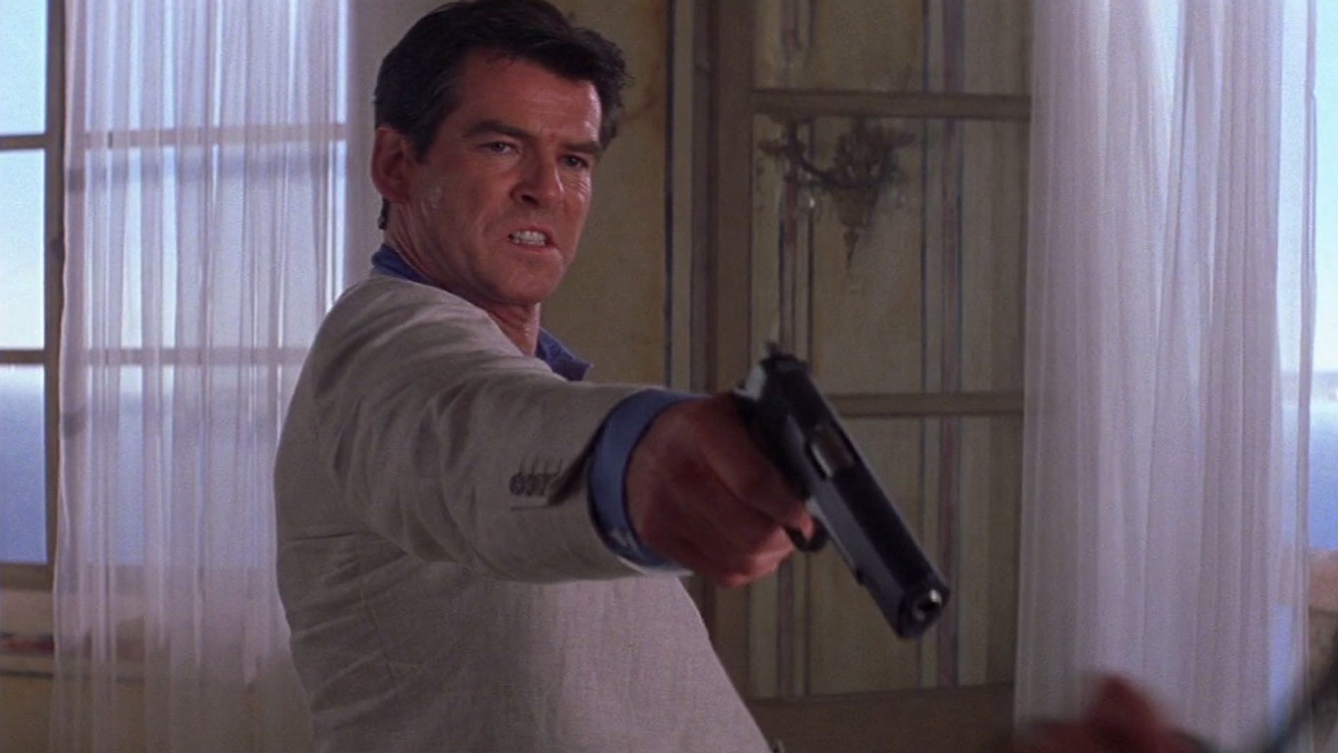 Pierce Brosnan as James Bond holding a gun HD Wallpaper