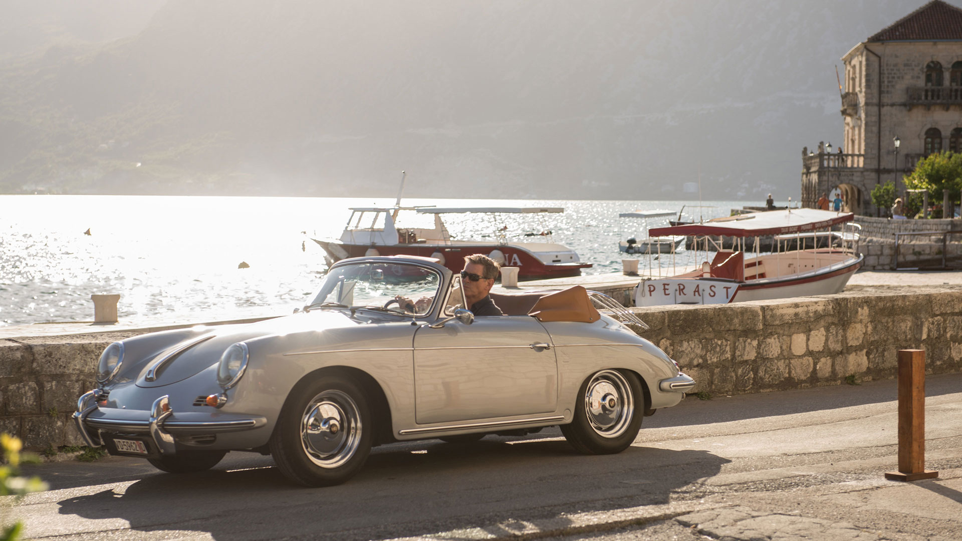 Pierce Brosnan driving a vintage Porsche convertible in Perast HD Wallpaper