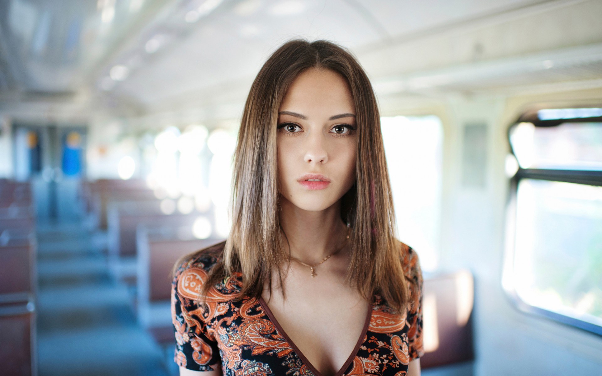 Woman in a patterned dress on a train HD Wallpaper