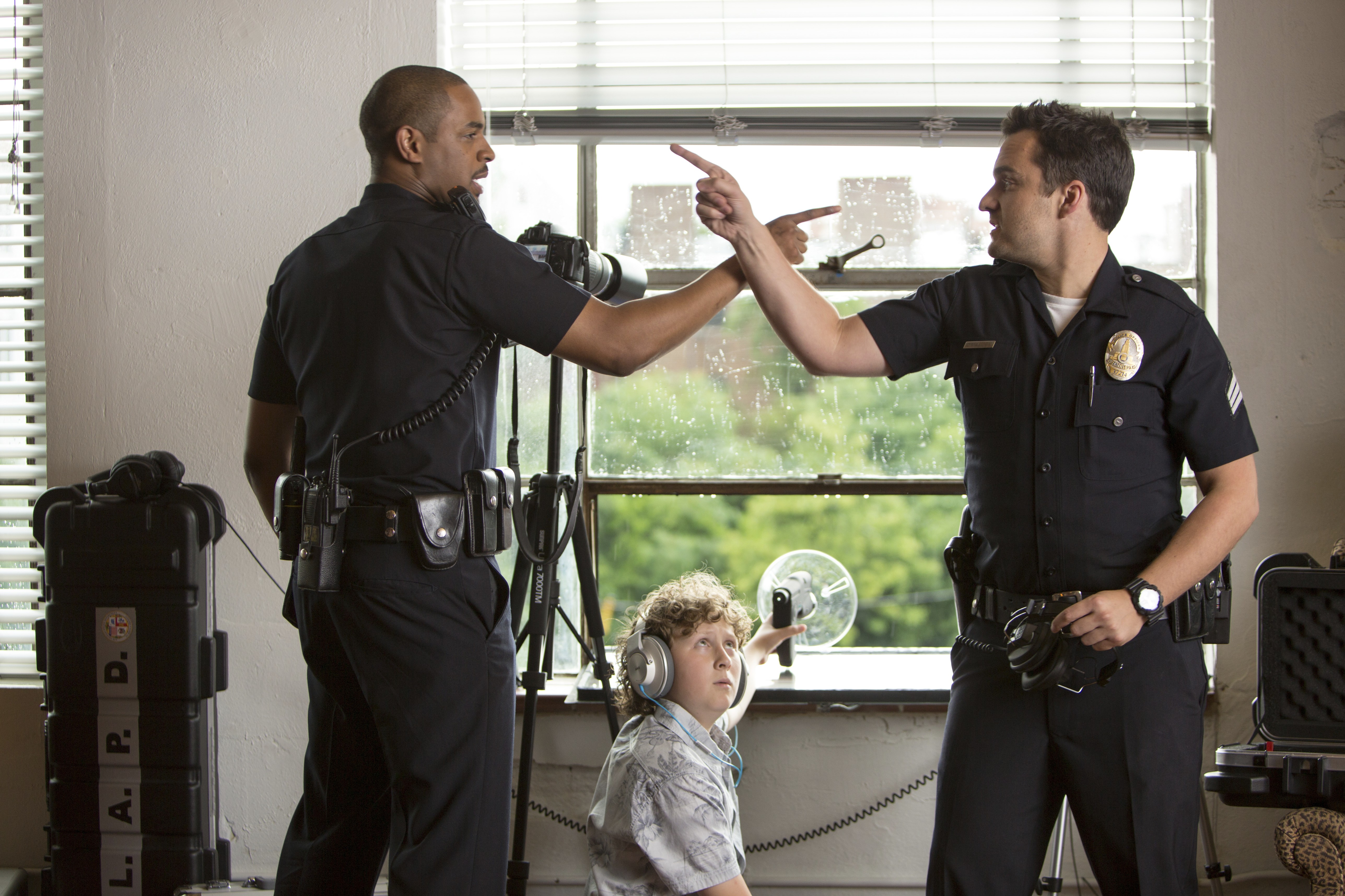Two LAPD officers and a boy with headphones HD Wallpaper