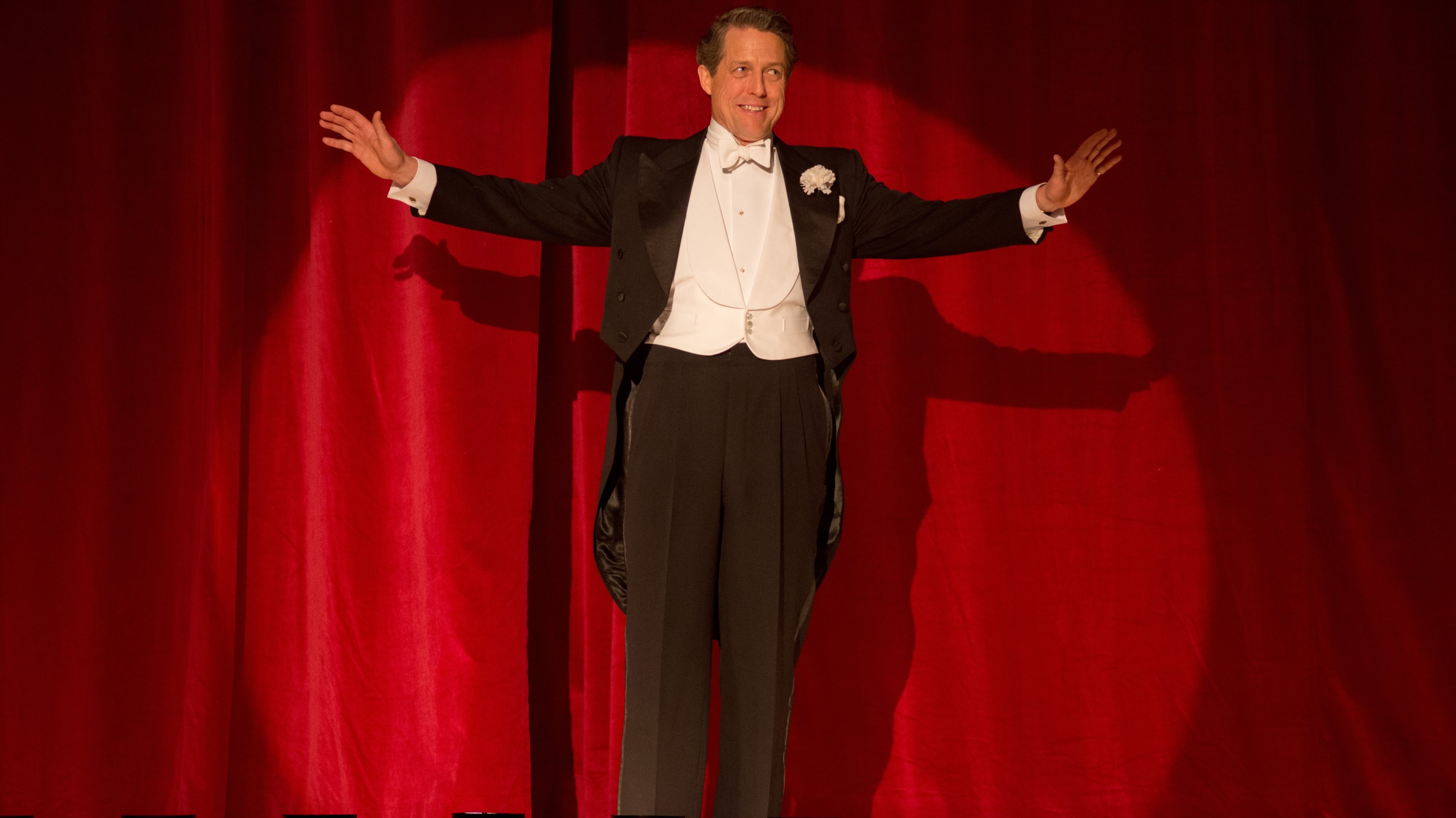 Hugh Grant in a tuxedo on stage HD Wallpaper