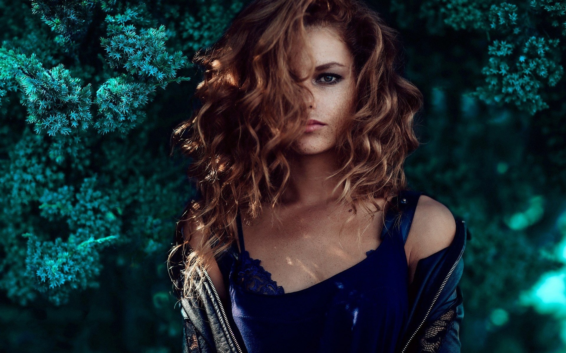 Woman with curly hair in blue top and jacket HD Wallpaper